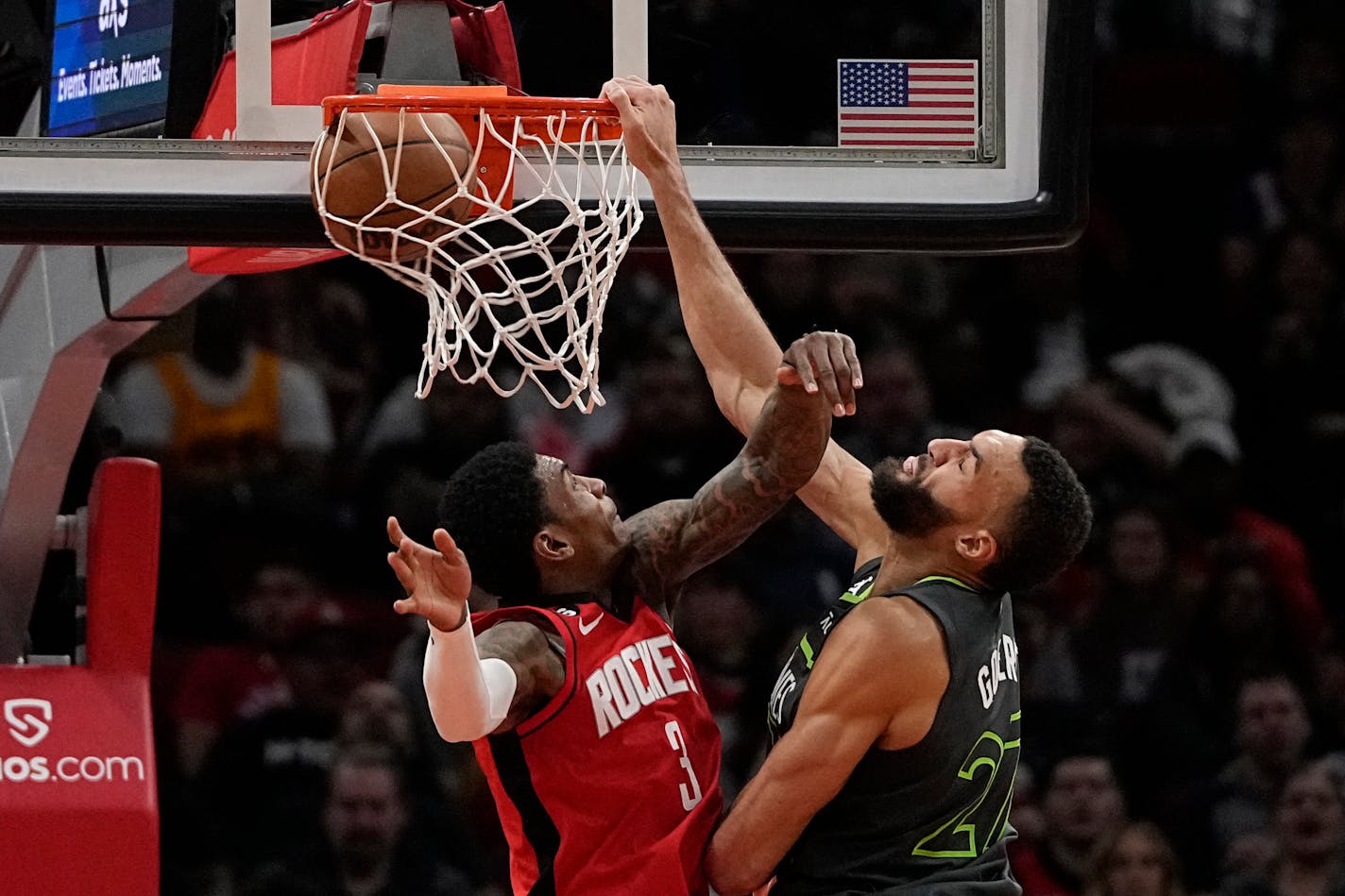 Minnesota Timberwolves' Rudy Gobert (27) dunks the ball as Houston Rockets' Kevin Porter Jr. (3) defends during the second half of an NBA basketball game Sunday, Jan. 8, 2023, in Houston. The Timberwolves won 104-96. (AP Photo/David J. Phillip)