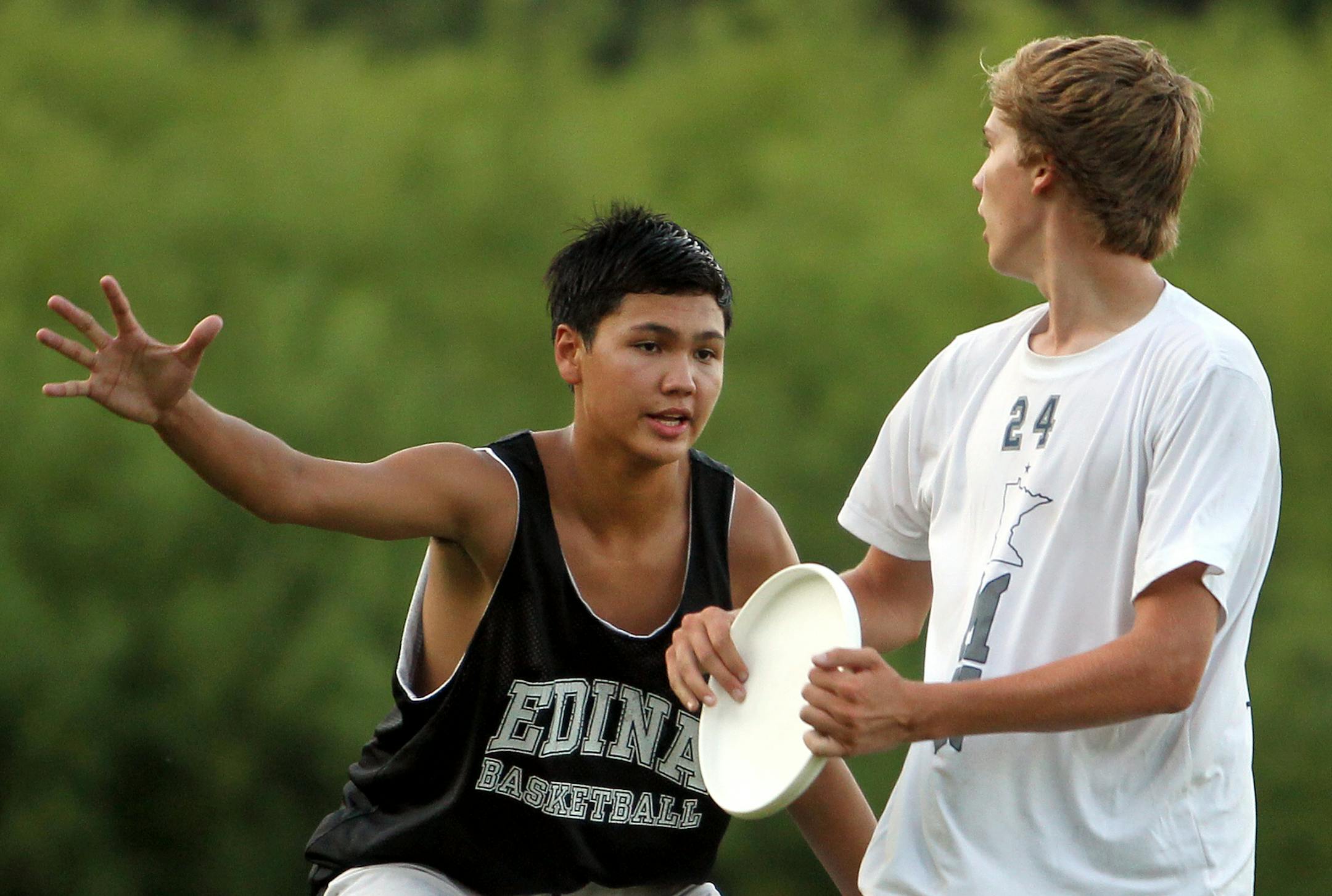 Conor Kline, left, plays defense against Ryan Berg during a practice for the sport ultimate at Edina High School in Edina, Minn., on Thursday, August 1, 2013. ] (ANNA REED/STAR TRIBUNE) anna.reed@startribune.com (cq)