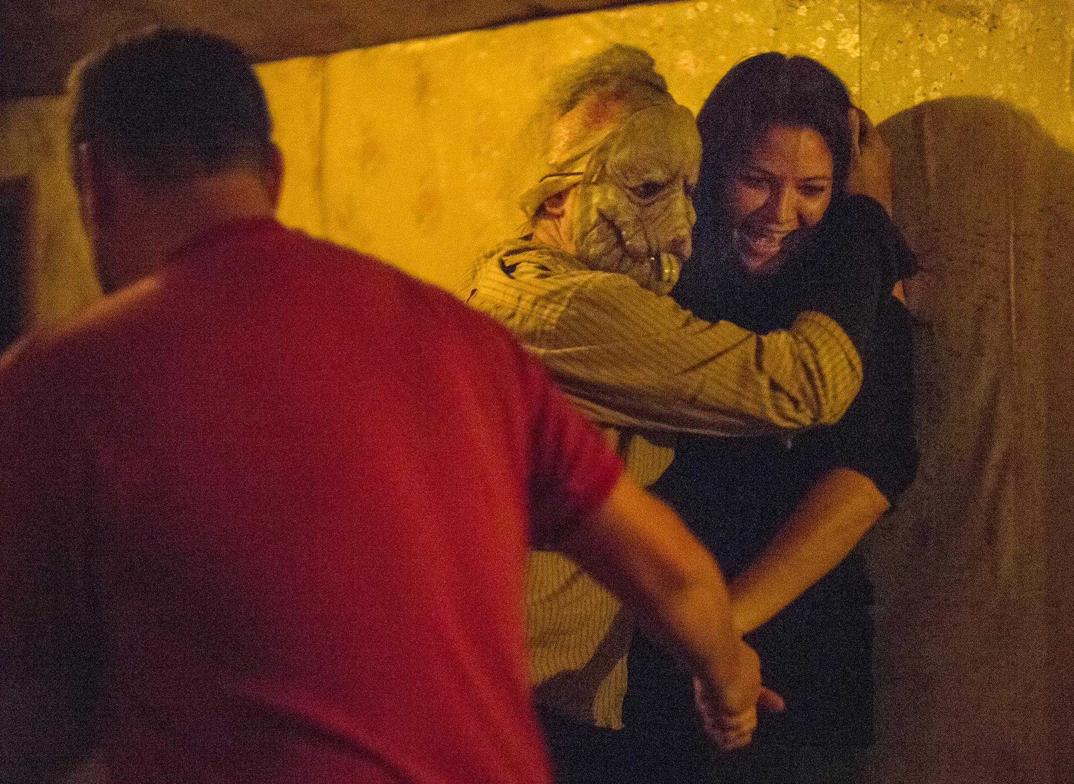Creepy characters come out of the dark to greet you — or hug you — at the Haunted Basement.