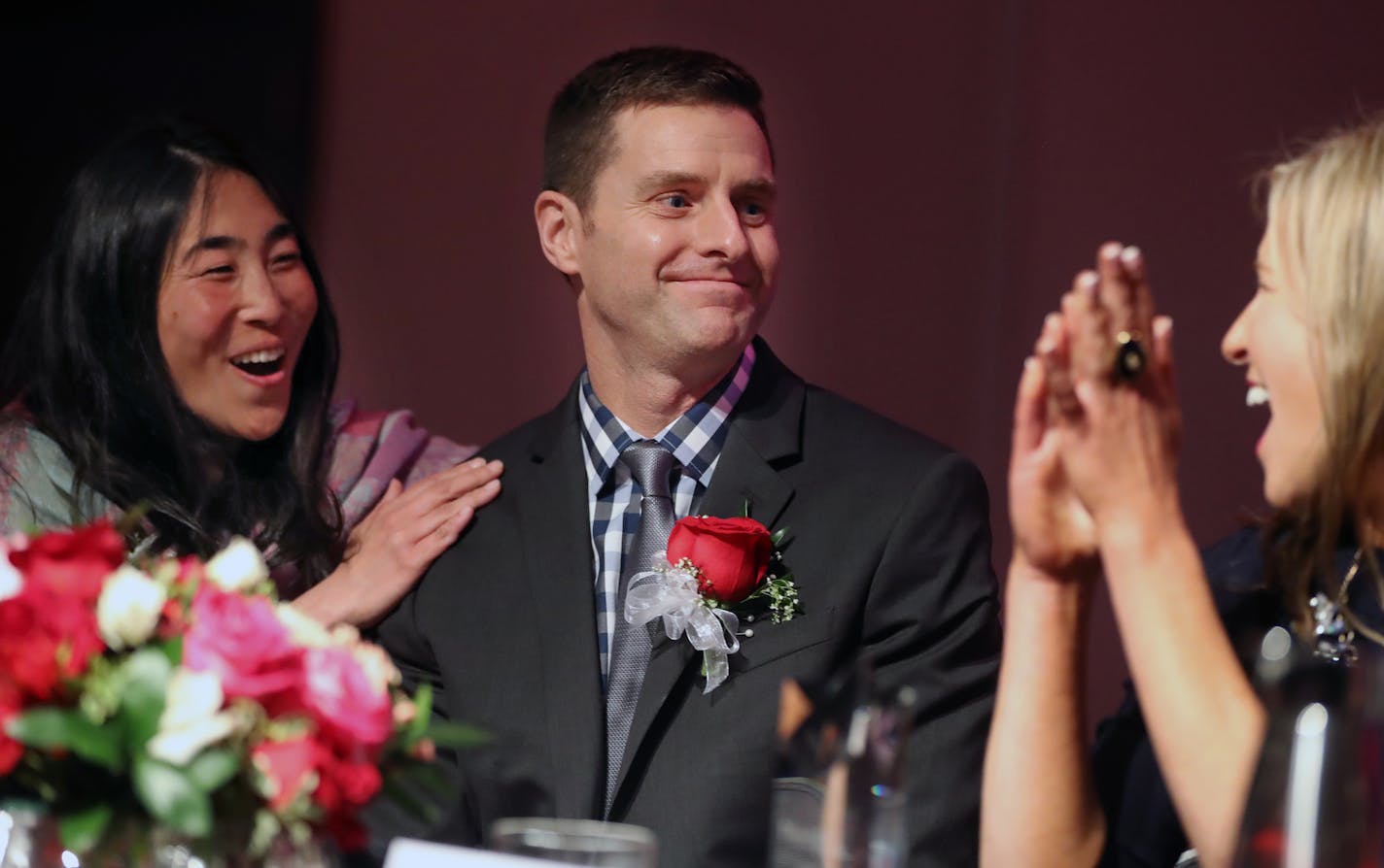 Corey Bulman is congratulated by finalists Alie Alowonle and Greta Callahan,right for being named Minnesota H.S. Teacher of the Year.]Corey Bulman, who teaches at Mound Westonka High School is the Minnesota H.S. Teach of the Year.