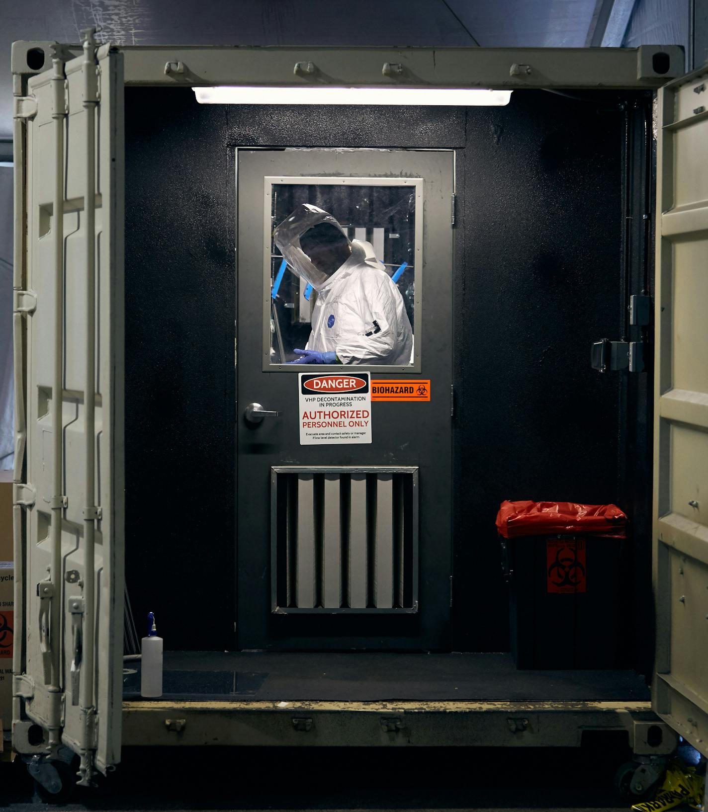 A researcher loads used masks into the decontamination chamber at Batelle in Columbus, Ohio on April 2, 2020. Under a sprawling tent in a parking lot near the small town of West Jefferson, employees of Battelle, a nonprofit research and development firm, have spent the recent weeks decontaminating over 30,000 used face masks for doctors and nurses on the front lines of the coronavirus pandemic. (Brian Kaiser/The New York Times)