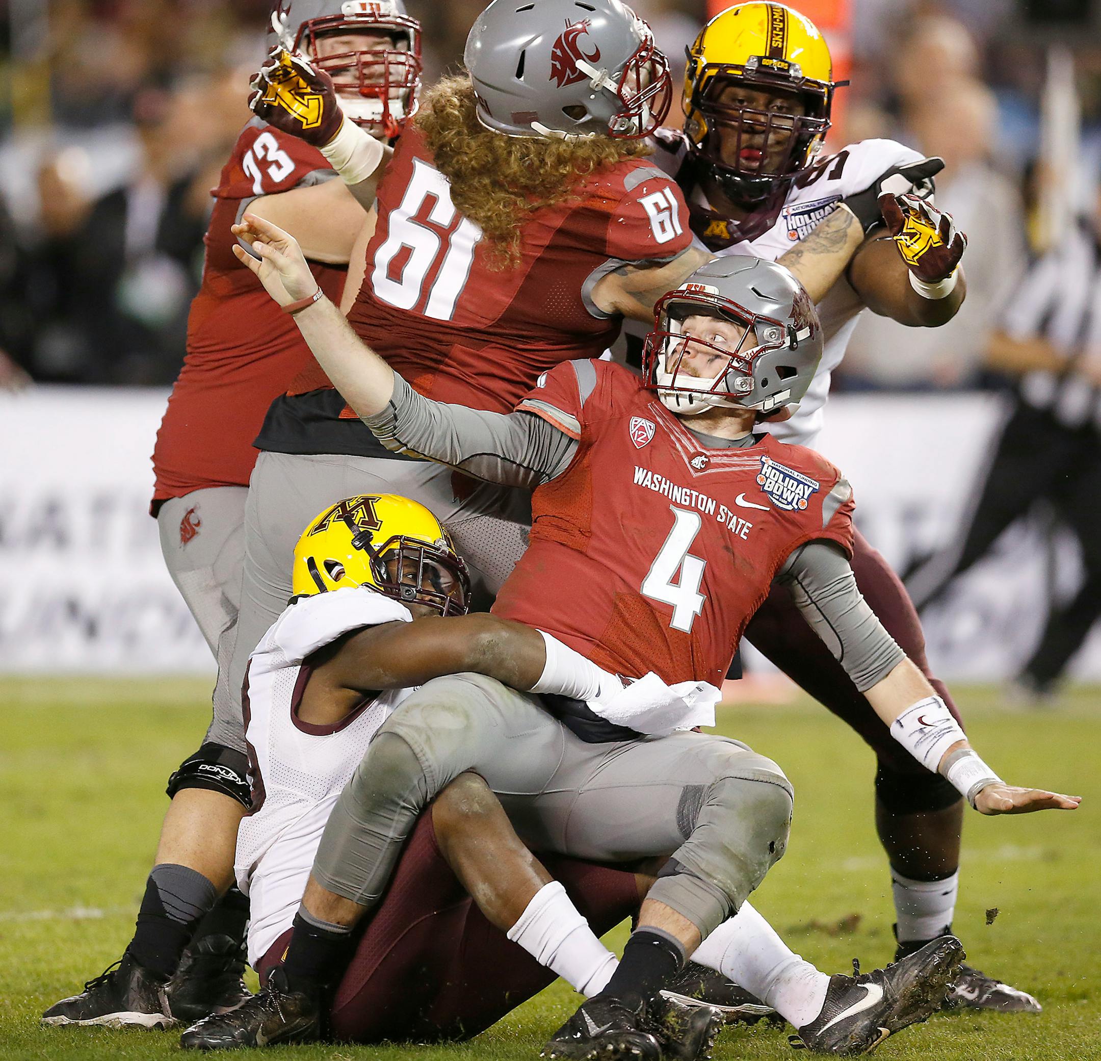 Minnesota's linebacker Jonathan Celestin, left, and Minnesota's defensive lineman Scott Ekpe sacked Washington State's quarterback Luke Falk during the fourth quarter as they took on Washington State at Qualcomm Stadium for the San Diego Holiday Bowl, Tuesday, December 27, 2016 in San Diego, CA.