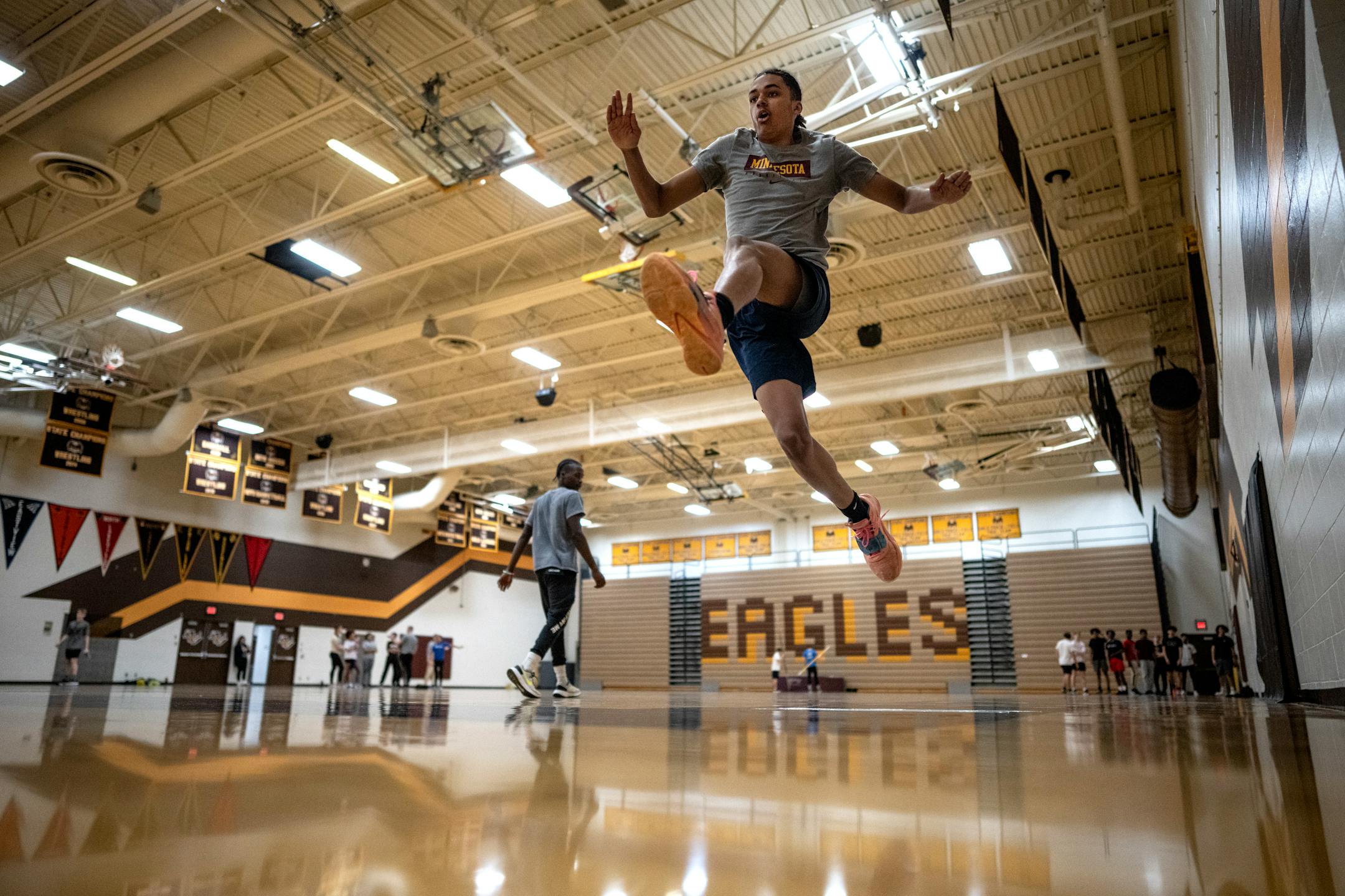 Jaylen Barrow of Apple Valley High practiced the long jump during practice in the gymnasium.