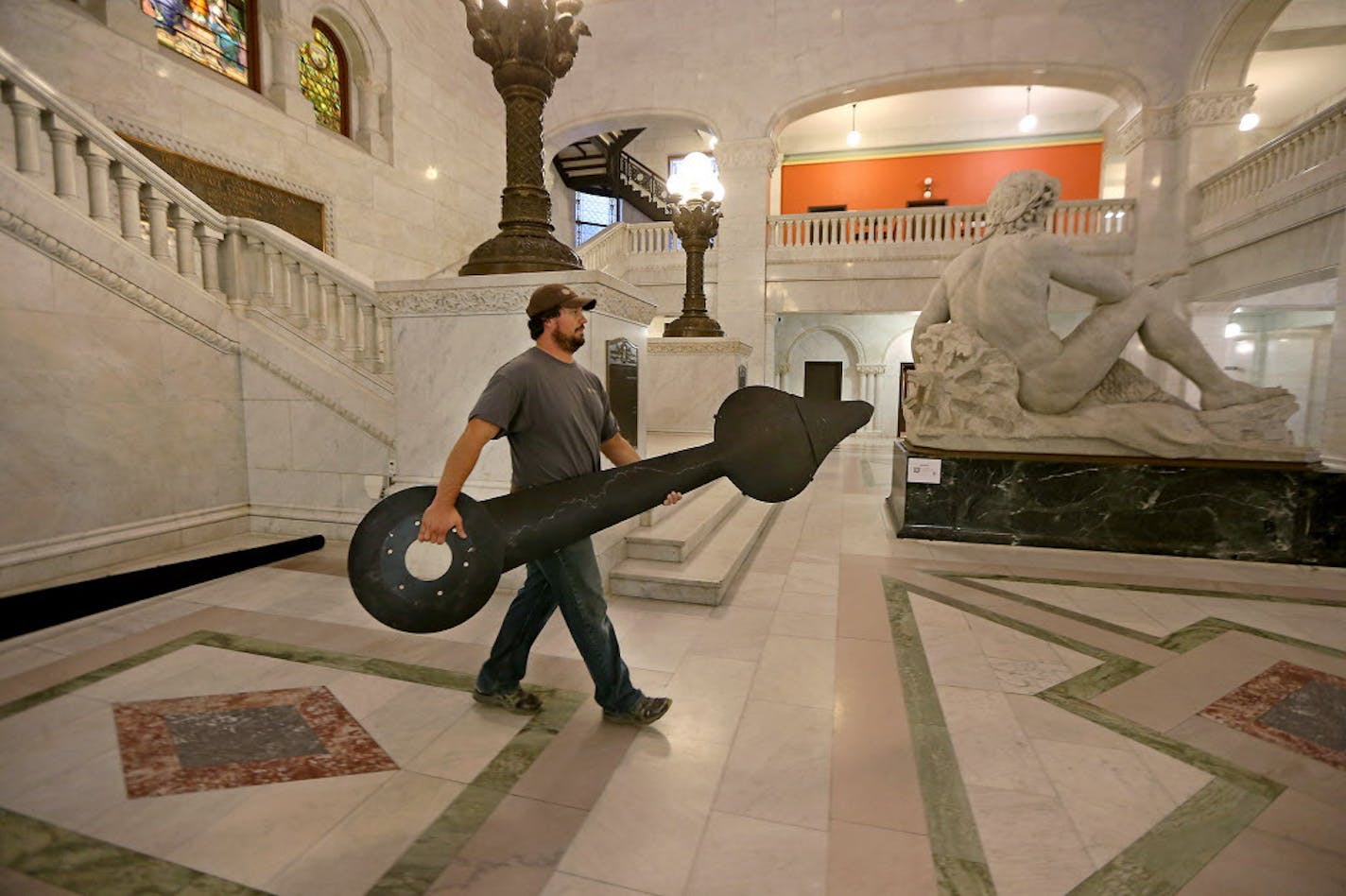 Brandon Smoley carried one of the hands of the City Hall Clock to an area where it will be packaged and shipped to to St. Louis for repairs, Monday, October 3, 2016 in St. Paul, MN. ] (ELIZABETH FLORES/STAR TRIBUNE) ELIZABETH FLORES &#xef; eflores@startribune.com