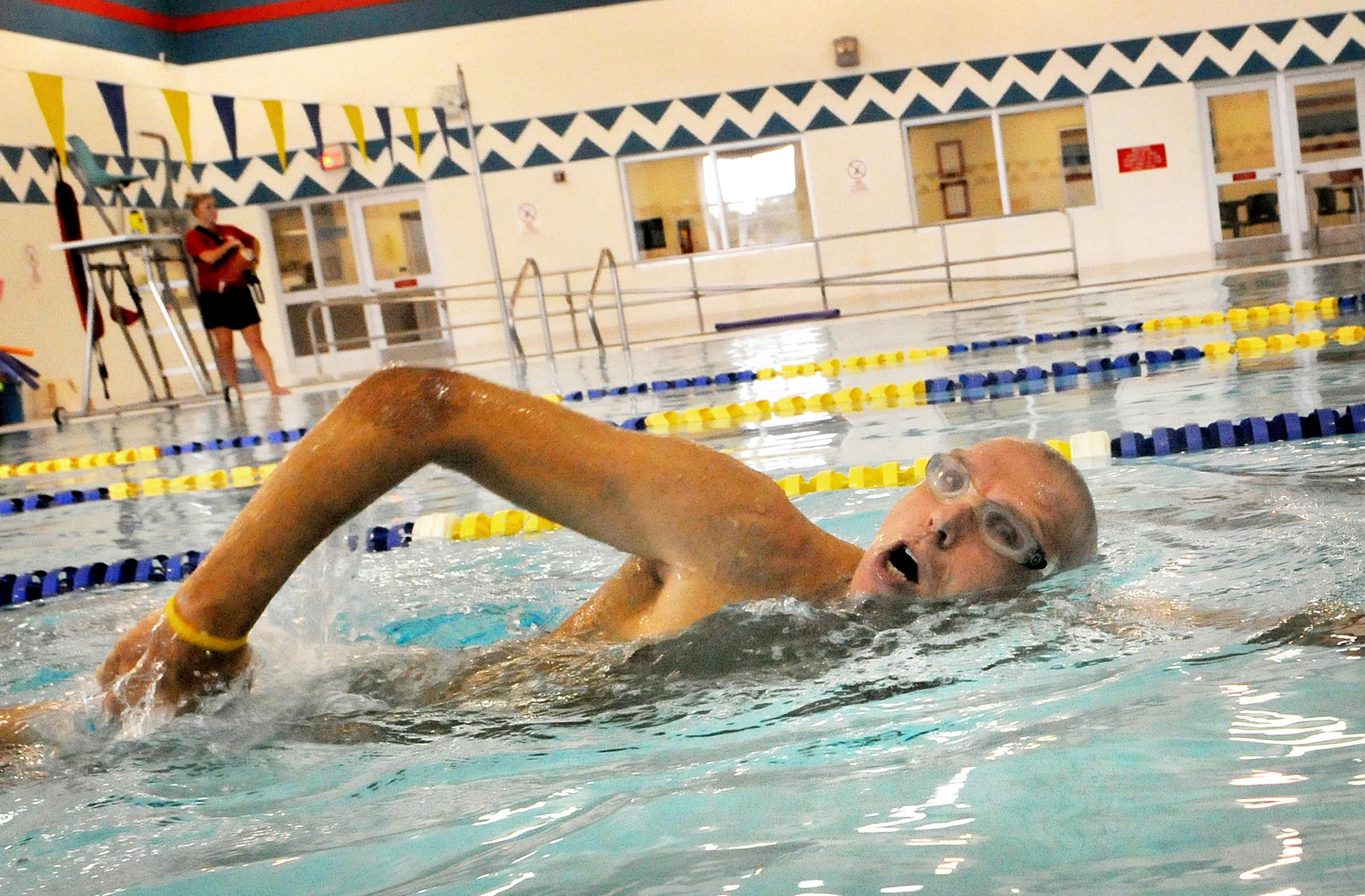 Less than two weeks after spinal surgery, Ron Troyer was back at the St. Croix Valley YMCA Monday to resume his regular swimming workouts. His incision scar can be seen on his back.