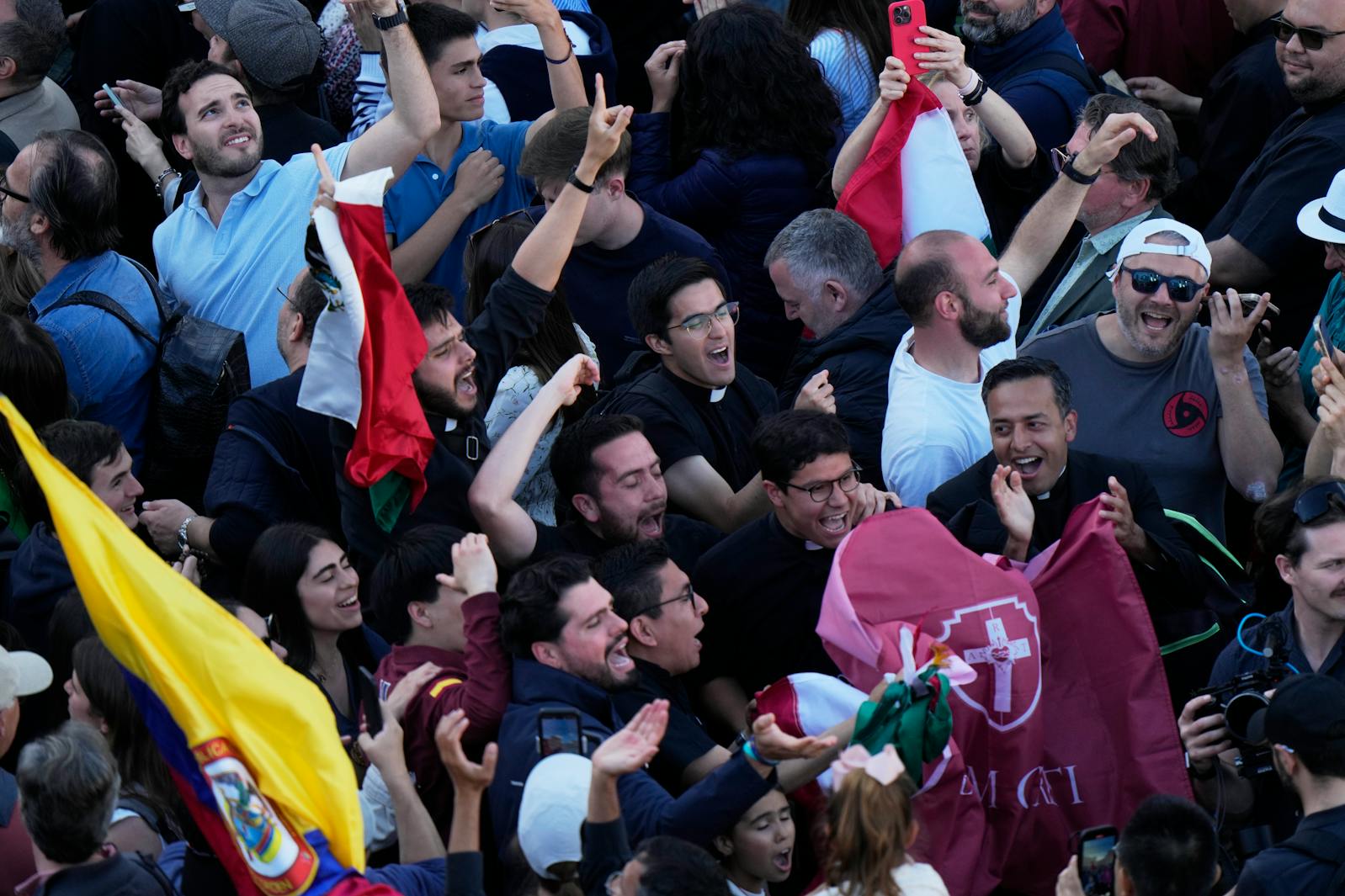 People cheered the white smoke billowing from the chimney of the Sistine Chapel where 133 cardinals are gathering on the second day of the conclave to elect a successor to late Pope Francis, at the Vatican, Thursday, May 8, 2025. 