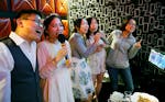 A young couple celebrated their wedding day with and after party at the karaoke restaurant and bar Encore. From Left, the couple Wenjun Zeng and Chang