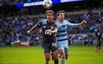 Minnesota United midfielder Adrien Hunou (23), left, and Sporting Kansas City defender Andreu Fontas (3) chase the ball in the Sporting box during the