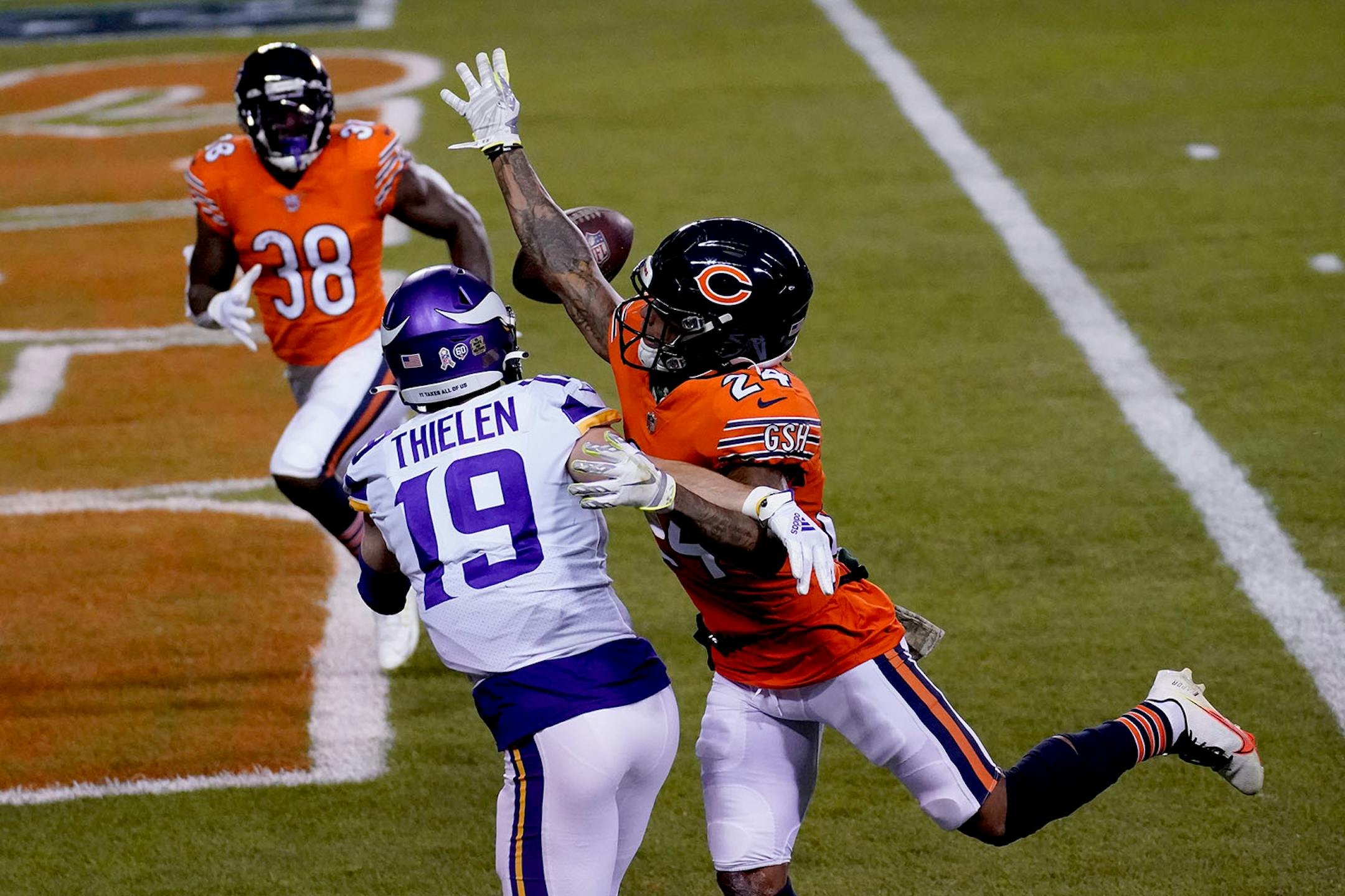 Minnesota Vikings wide receiver Adam Thielen (19) catches a touchdown pass as Chicago Bears cornerback Buster Skrine (24) and safety Tashaun Gipson Sr. (38) defend during the first half of an NFL football game Monday, Nov. 16, 2020, in Chicago. (AP Photo/Charles Rex Arbogast)