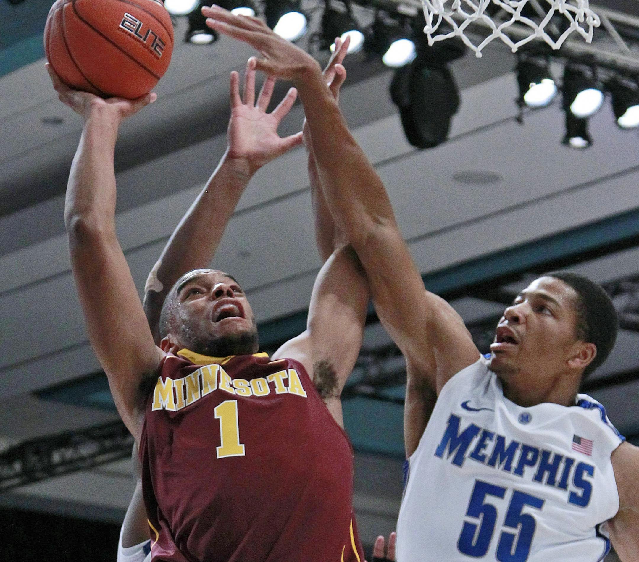Minnesota guard Andre Hollins (1) goes to the basket as Memphis guard Geron Johnson (55) during Hollins' 41-point game on Friday.