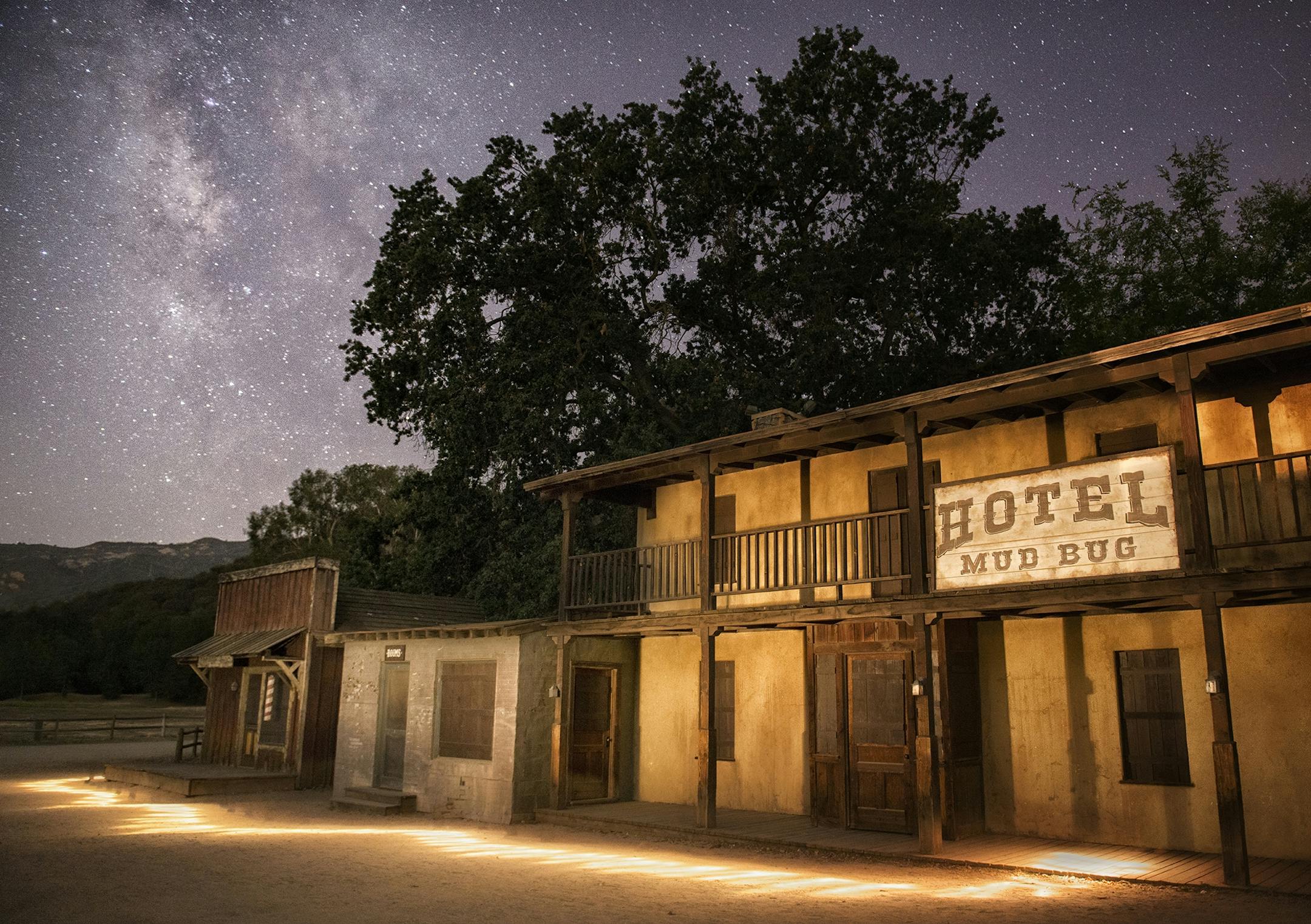 ONE TIME USE. Paramount Ranch in the Santa Monica Mountains National Recreation Area in Southern California is home to a western movie set that will be familiar to many. Among its varied gems is the Mudbug Hotel, where it is easy to imagine ghosts flitting about. Perhaps the camera caught one in action here, dancing under the stars of the Milky Way?