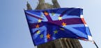 A British Union flag is flown behind a European Union flag, backdropped by Parliament in London, Wednesday, April 10, 2019. Just days away from a no-d
