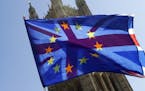 A British Union flag is flown behind a European Union flag, backdropped by Parliament in London, Wednesday, April 10, 2019. Just days away from a no-d