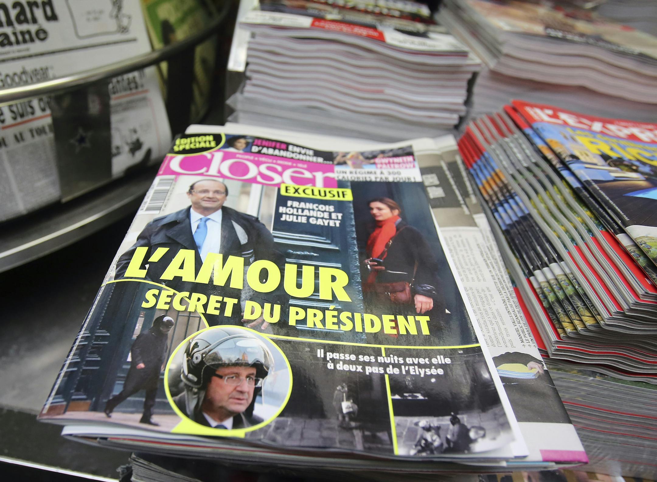 The French magazine Closer with photos of French President Francois Hollande and French actress Julie Gayet on its front page, is presented in a newspaper stall on the Champs Elysee Avenue in Paris, Friday Jan. 10, 2013. French President Francois Hollande is threatening legal action over the magazine report saying he is having a secret affair with the French actress Julie Gayet. Hollande, in a statement obtained by The Associated Press, says he "deeply deplores the attacks on respect for privacy