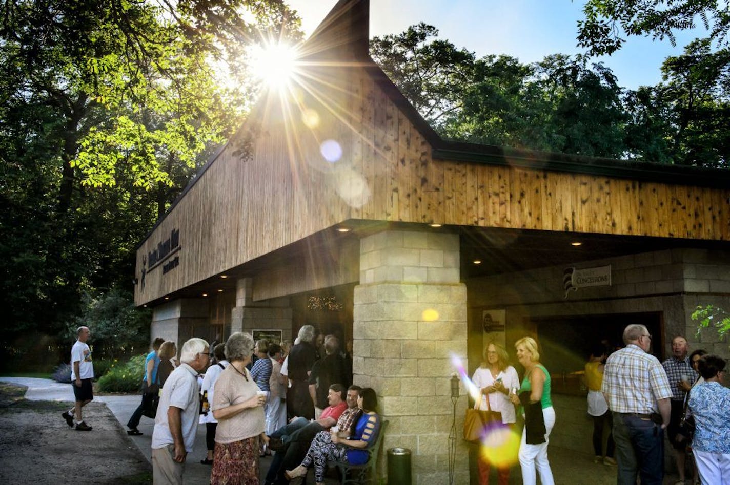 Patrons enjoyed drinks and warm summer breezes outside the theater before going in.