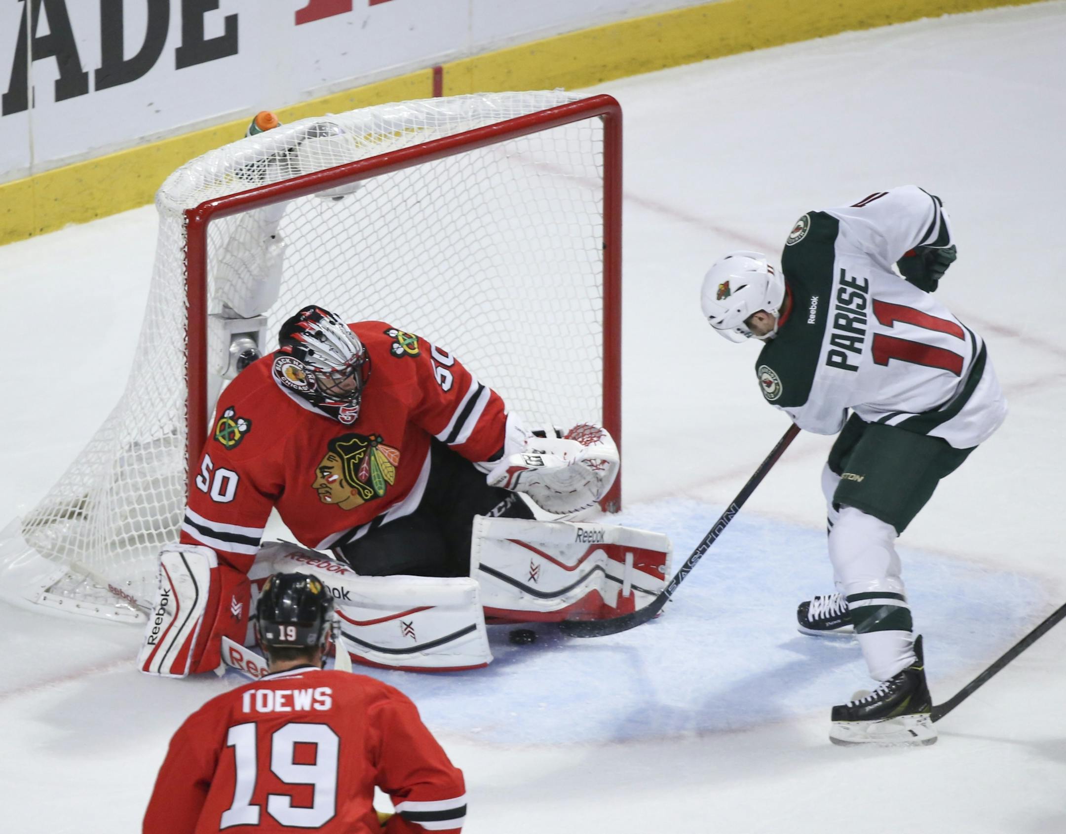 Minnesota left wing Zach Parise (11) slipped the puck in between the pads of Blackhawks goalie Corey Crawford for the Wild's second goal of the second period Friday night.