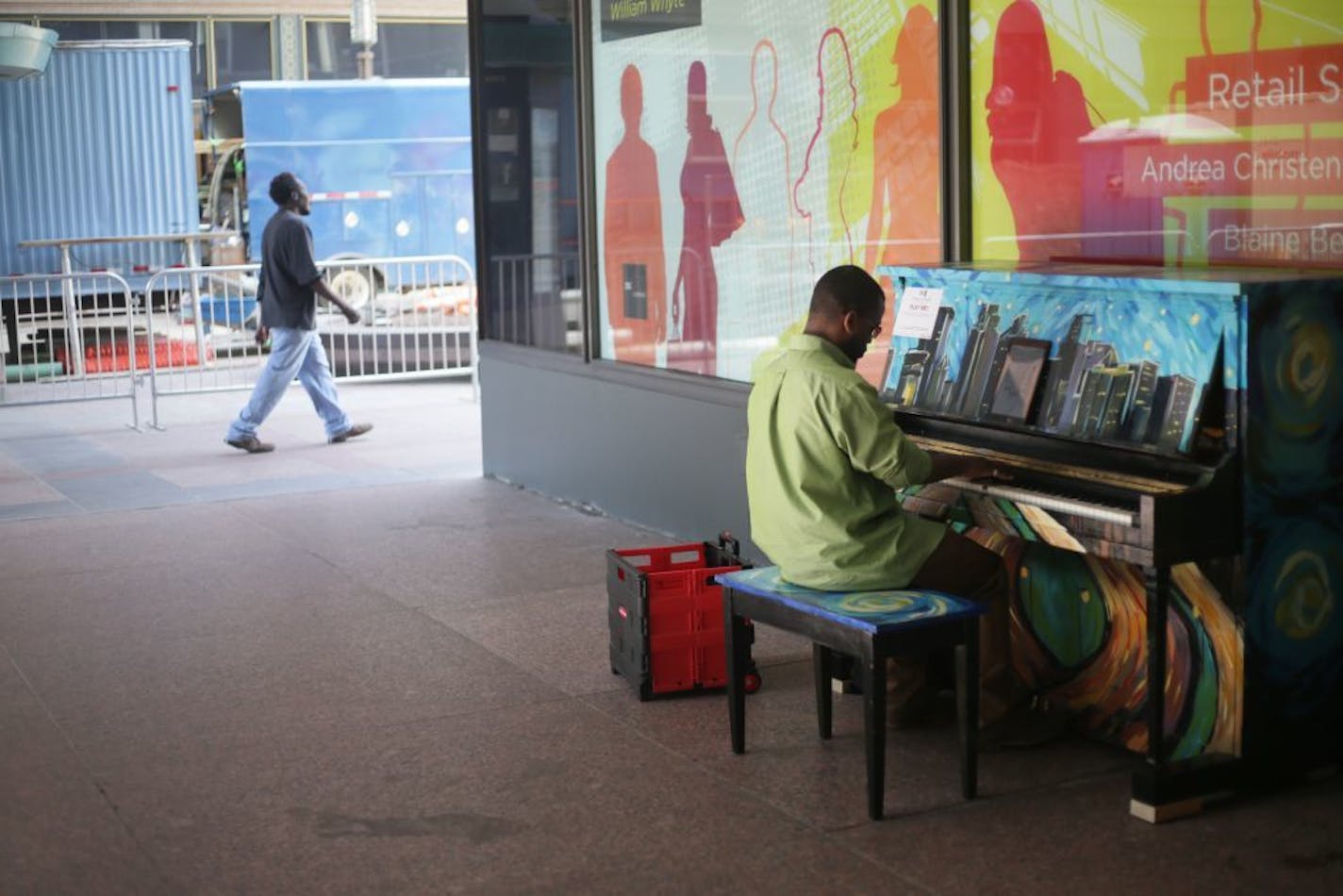 Walter Hampton of St. Paul plays a piano outside of the IDS Center on Wednesday, June 8, 2016. The piano, painted by artist Sam Basques, is one of 25 uniquely designed pianos available throughout Downtown Minneapolis during the month of June for the public to play through the month of June.