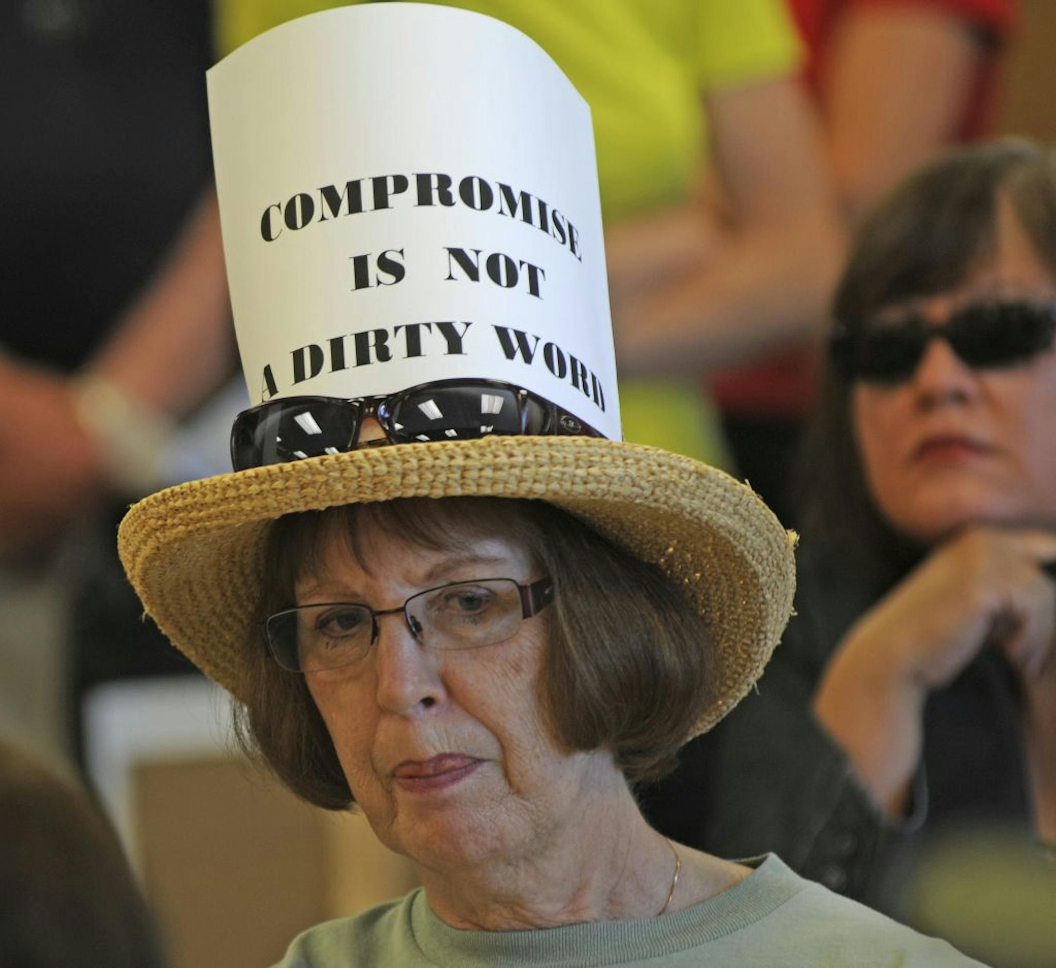 Joyce Gofff Savage, Minn. came to Congressman Erik Paulsen's office to voice her concern about the budget crisis. Her hat reads"Compromise is not a dirty word". MoveOn.org held an emergency mobilization concerning the Debt Ceiling Vote at Congressman Erik Paulsens office at the Star Bank in Eden Prarie, Minn. on Tuesday July 26,2011.