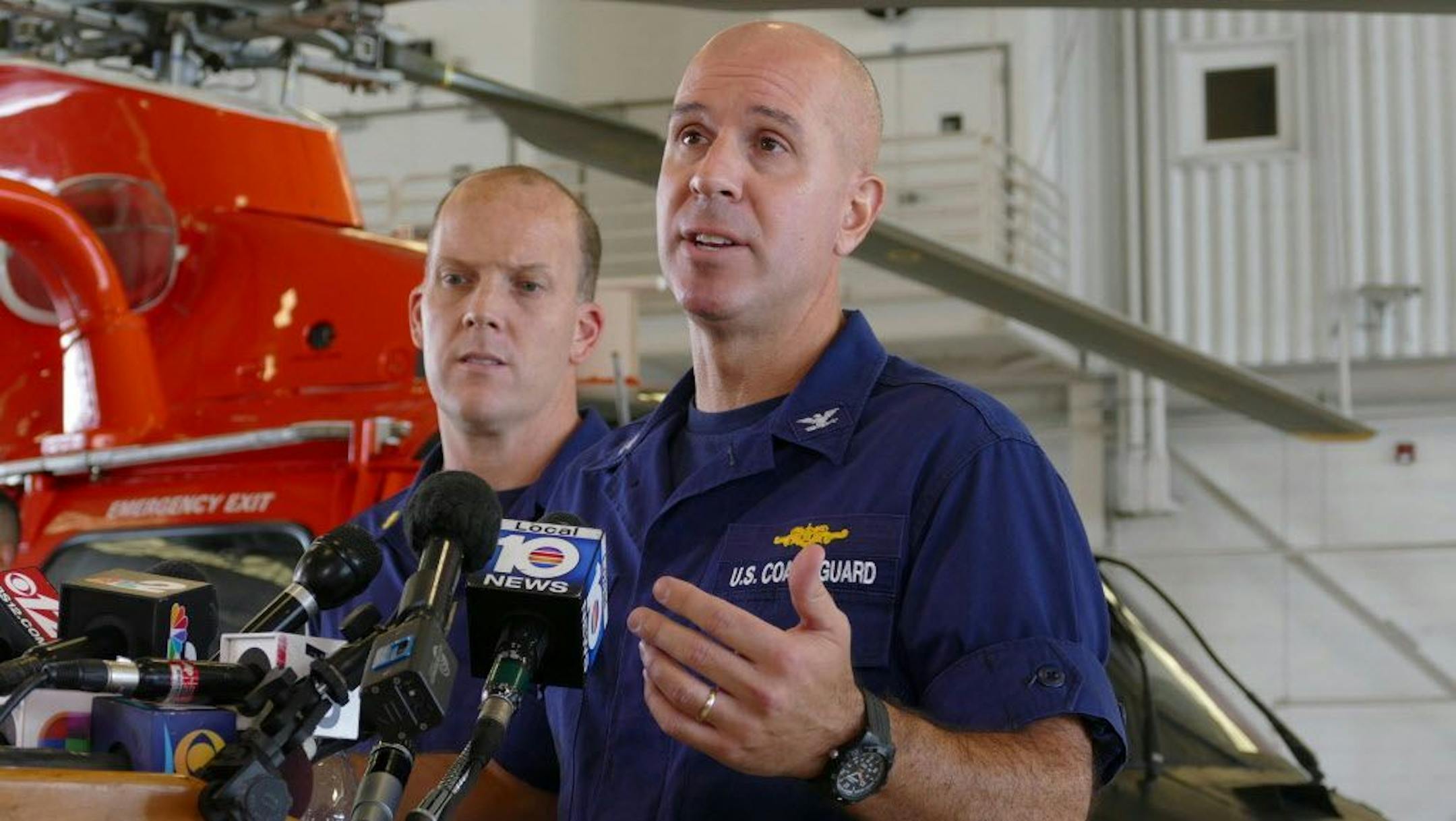 U.S.C.G. Cpt. Mark Fedor, right, and Lt. Cmd. Gabe Somma brief the media on the search for survivors of the cargo ship El Faro that sank during Hurricane Joaquin at the Coast Guard Station at the Opa Locka Airport on Monday, Oct. 5, 2015.
