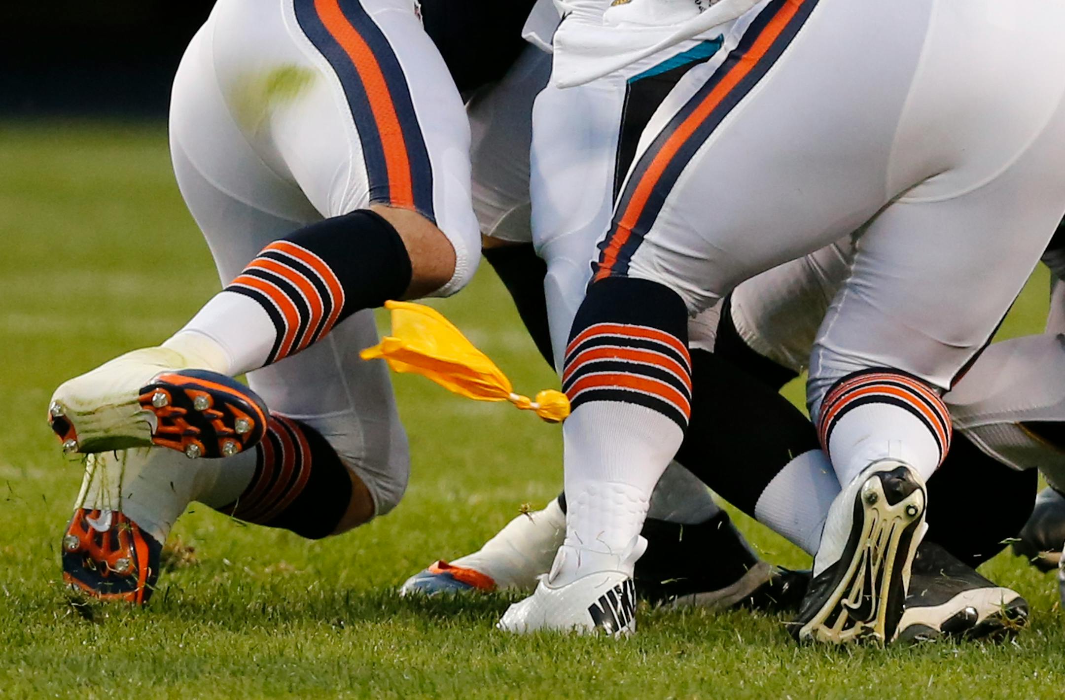 An official's penalty flag flies during the first half of an NFL preseason football game between the Chicago Bears and Jacksonville Jaguars in Chicago, Thursday, Aug. 14, 2014. (AP Photo/Charles Rex Arbogast)