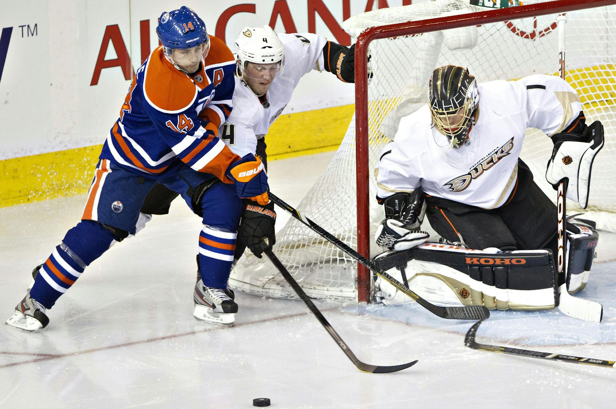 Anaheim Ducks goalie Jonas Hiller makes the save as Cam Fowler and Edmonton Oilers Jordan Eberle skate by during third period NHL hockey action in Edmonton, Alberta Sunday April 21, 2013. (AP Photo/ The Canadian Press, Janson Franson)