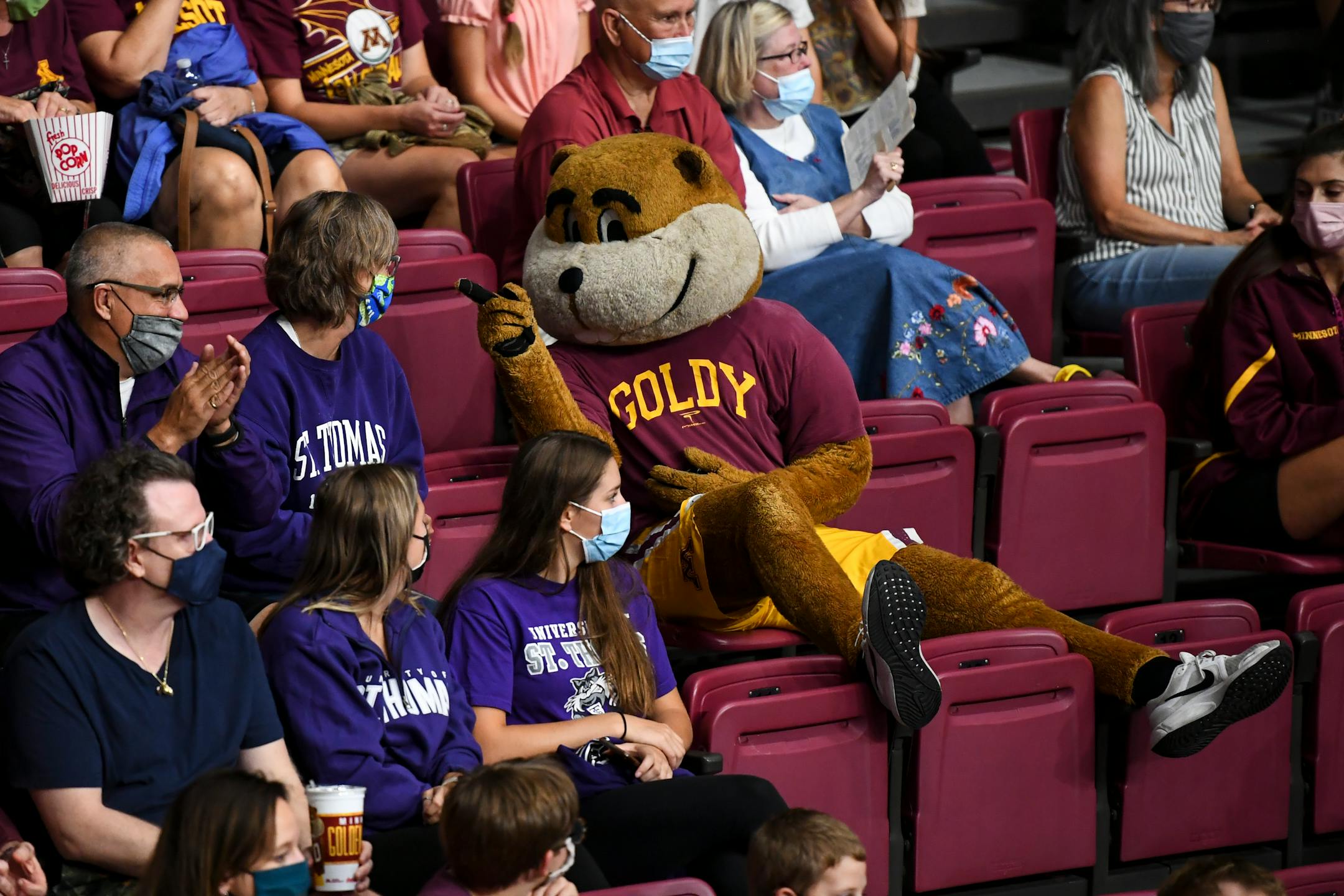 Goldy interacted with St. Thomas fans Eric and Debbie Monson, of Woodbury, and their daughters, Emma, left, and Kameron. 'It's never been done before, DIII to DI,' said Eric of St. Thomas.  'What a cool experience to play here at the pavilion!'