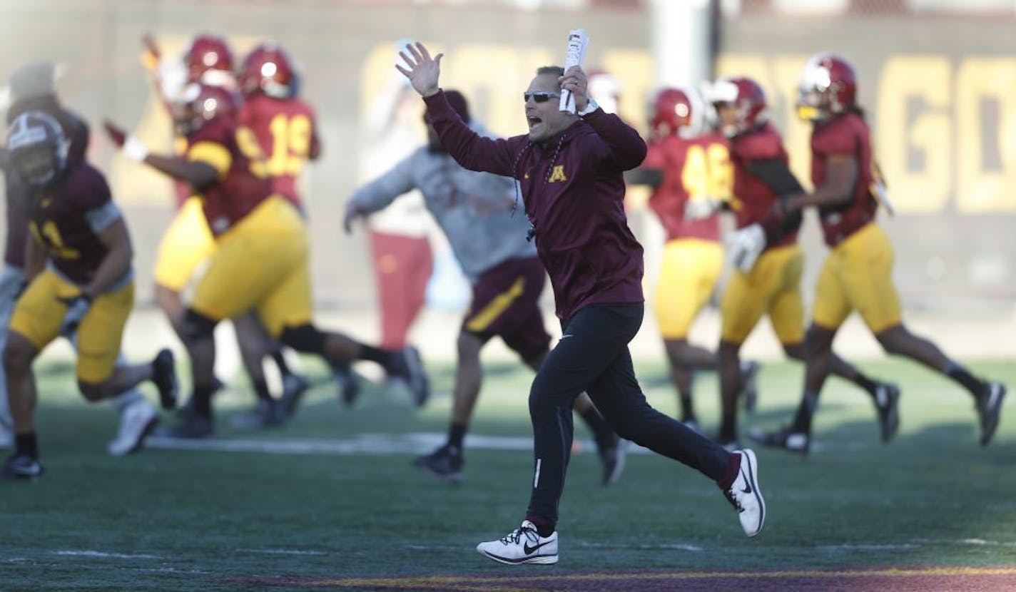 Gopher coach P.J. Fleck sprinted down the field with his team during football practice at the University of Minnesota Tuesday March 21, 2017 in Minneapolis, MN.
