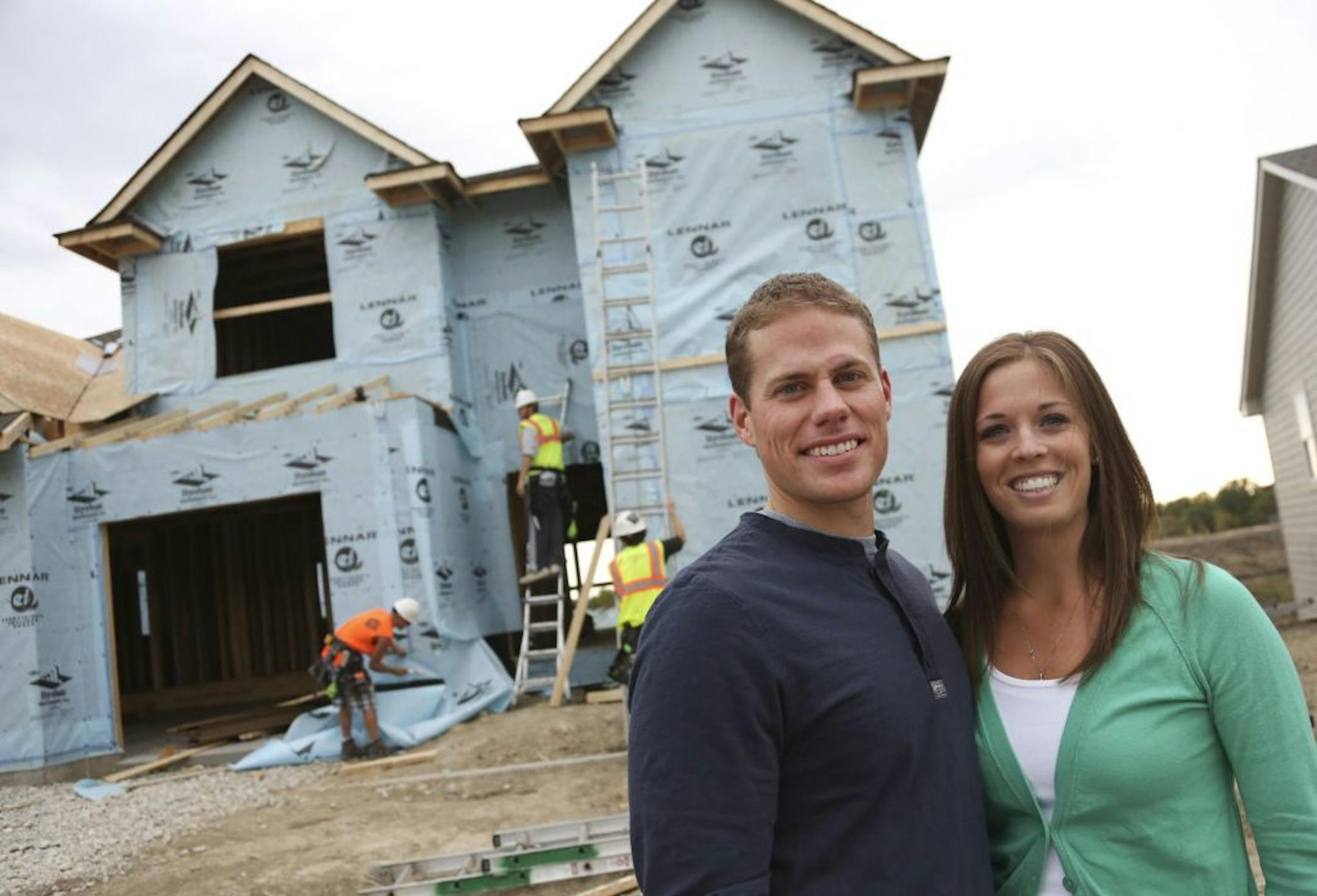 Mike and Ann Jeweson stood in front of their four-bedroom house they are having built in Medina Min., Thursday September 20, 2012. The couple are in their 20s and due to low interest rates this big home as their starter home.