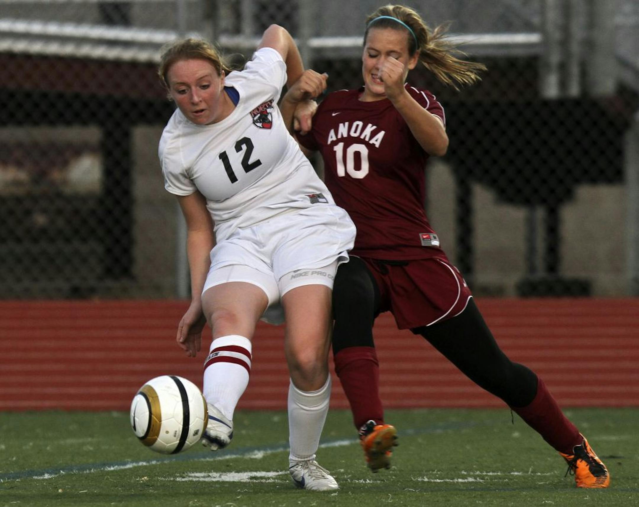 Lakeville North's Taylor Brownrigg got off a pass while fighting for position with Anoka's Kaitlin Beckman during the first half of their 2A girls' soccer quarterfinal match on Wednesday at Hopkins High. Lakeville North won 3-0.