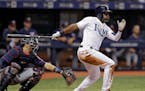 Tampa Bay Rays' Denard Span, right, lines a two-run double off Minnesota Twins starting pitcher Lance Lynn during the fifth inning of a baseball game 