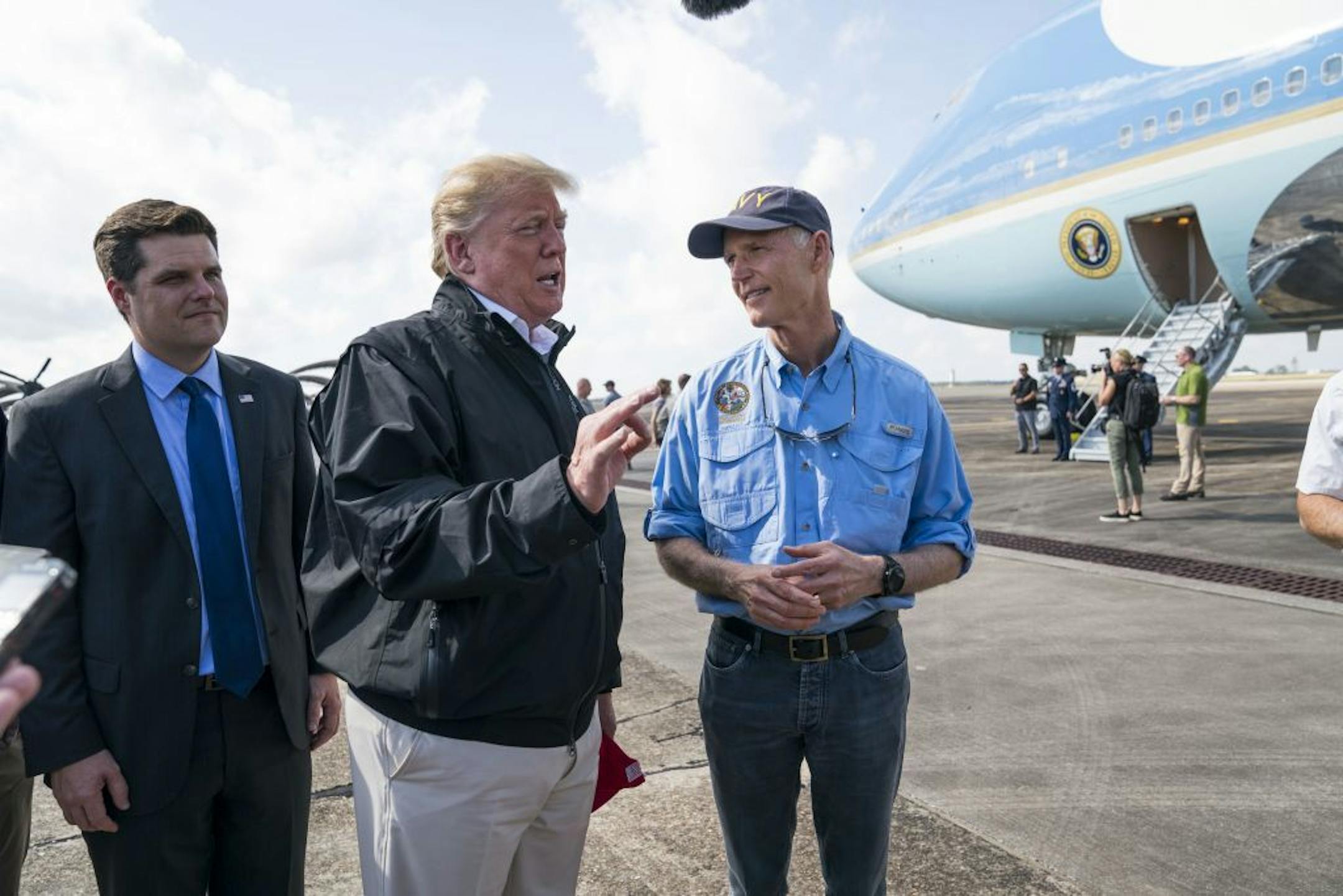 President Donald Trump is greeted by Florida Gov. Rick Scott, right, and Rep. Matt Gaetz (R-Fla.), left, upon arrival at Eglin Air Force Base in Florida, Oct. 15, 2018. Trump and first lady Melania Trump landed in Florida Monday to tour the damage from another hurricane, Michael, which tore through the Florida Panhandle last week, leaving a path of utter destruction behind it.
