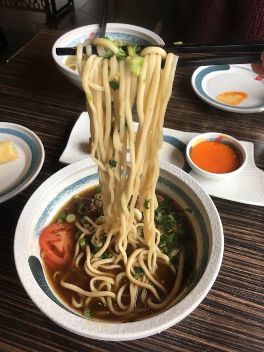 Freshly made noodles in a soup.