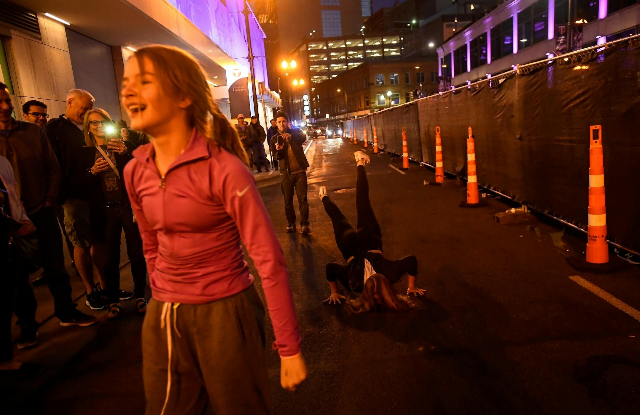A young fan danced "the worm" in 7th street as First Ave's Prince memorial block party took place on the other side of the barriers.