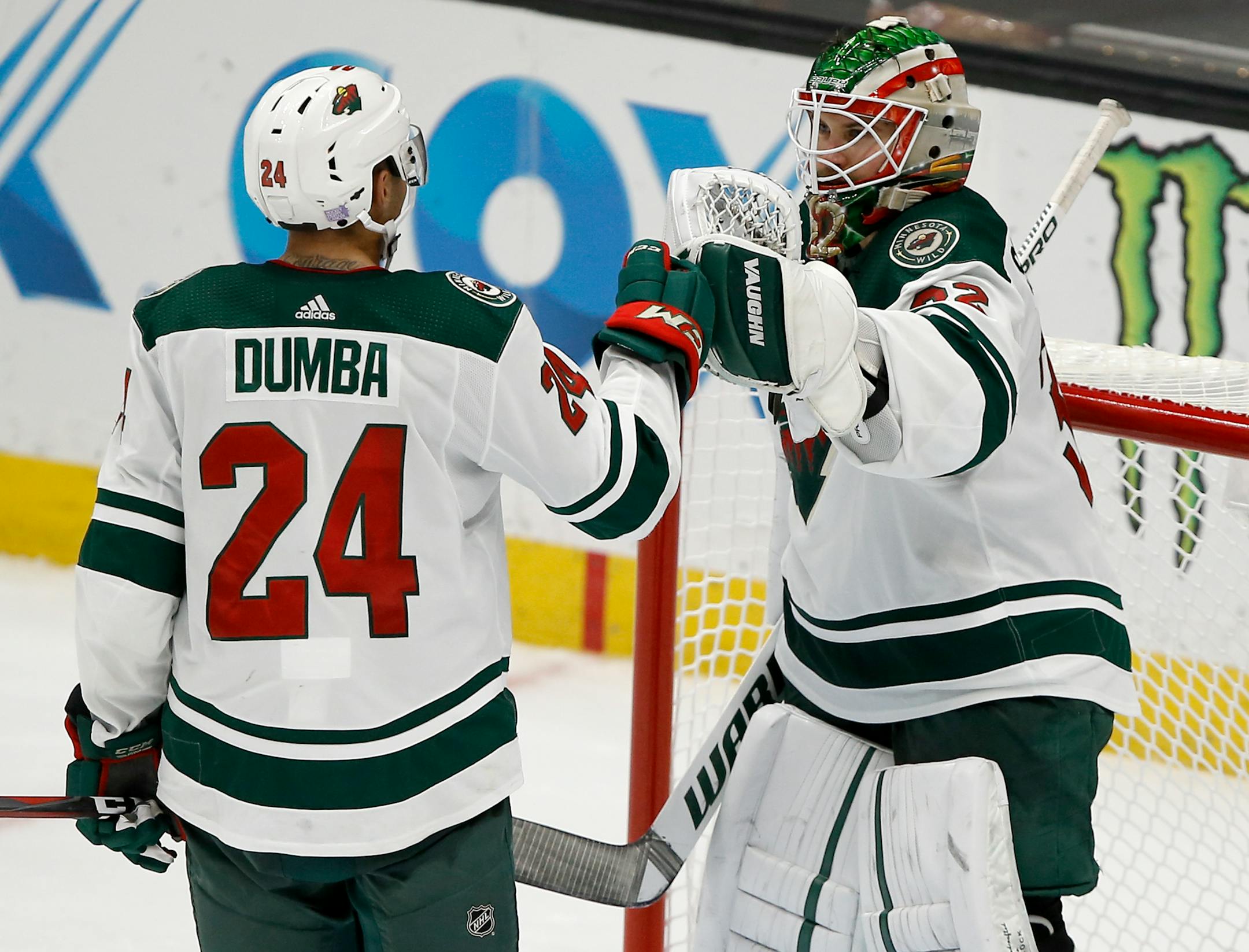 Wild goaltender Alex Stalock celebrates with defenseman Matt Dumba after the Wild defeated Anaheim on Nov. 9