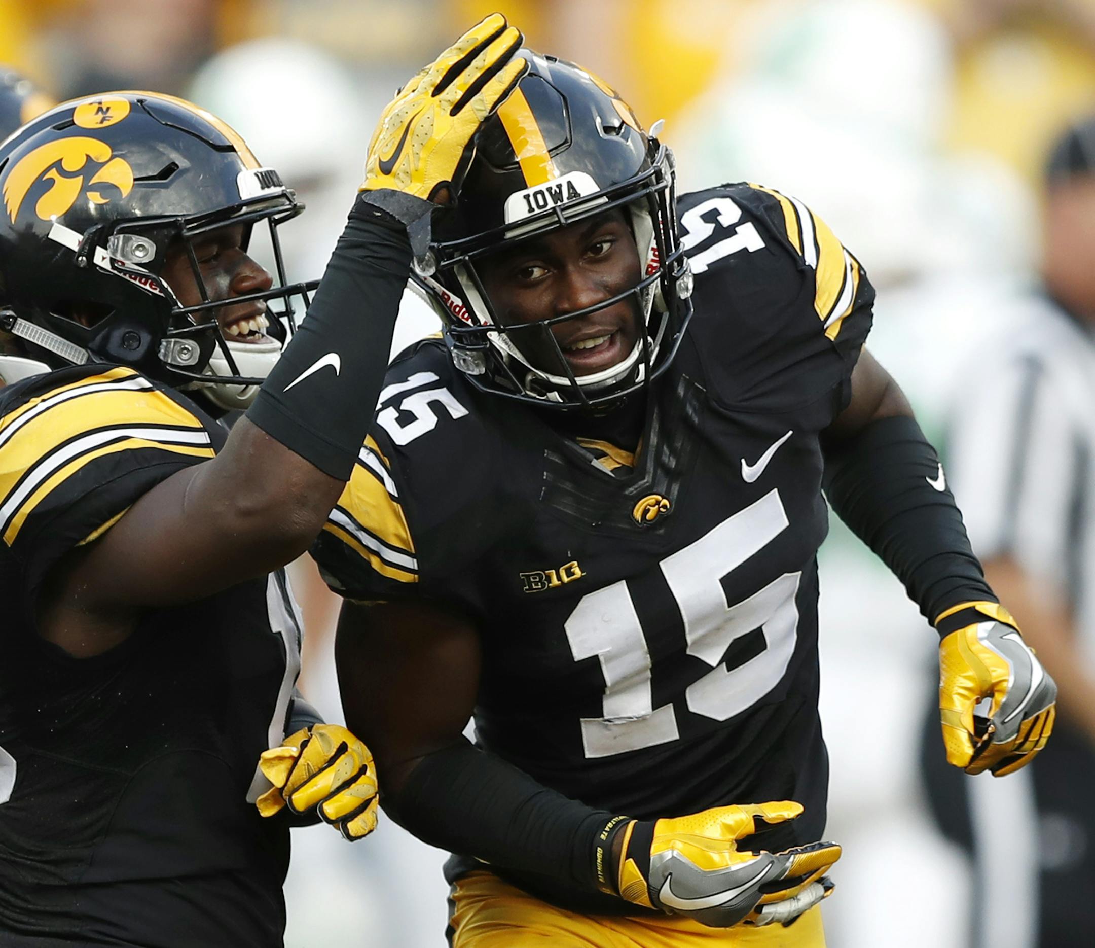 FILE - In this Sept. 16, 2017, file photo, Iowa's Josh Jackson (15) celebrates with teammate Miles Taylor, left, after intercepting a pass during the second half of an NCAA college football game against North Texas, in Iowa City, Iowa. Next week&#xed;s Pinstripe Bowl in New York could be Iowa junior cornerback Josh Jackson&#xed;s last game as a Hawkeye. Jackson said Tuesday, Dec. 19. 2017, that he&#xed;s &#xec;50-50&#xee; on whether he&#xed;ll come back for his senior season, adding that he&#xed