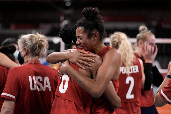 Players from the United States react after defeating Brazil in the gold medal match in women's volleyball at the 2020 Summer Olympics, Sunday, Aug. 8,