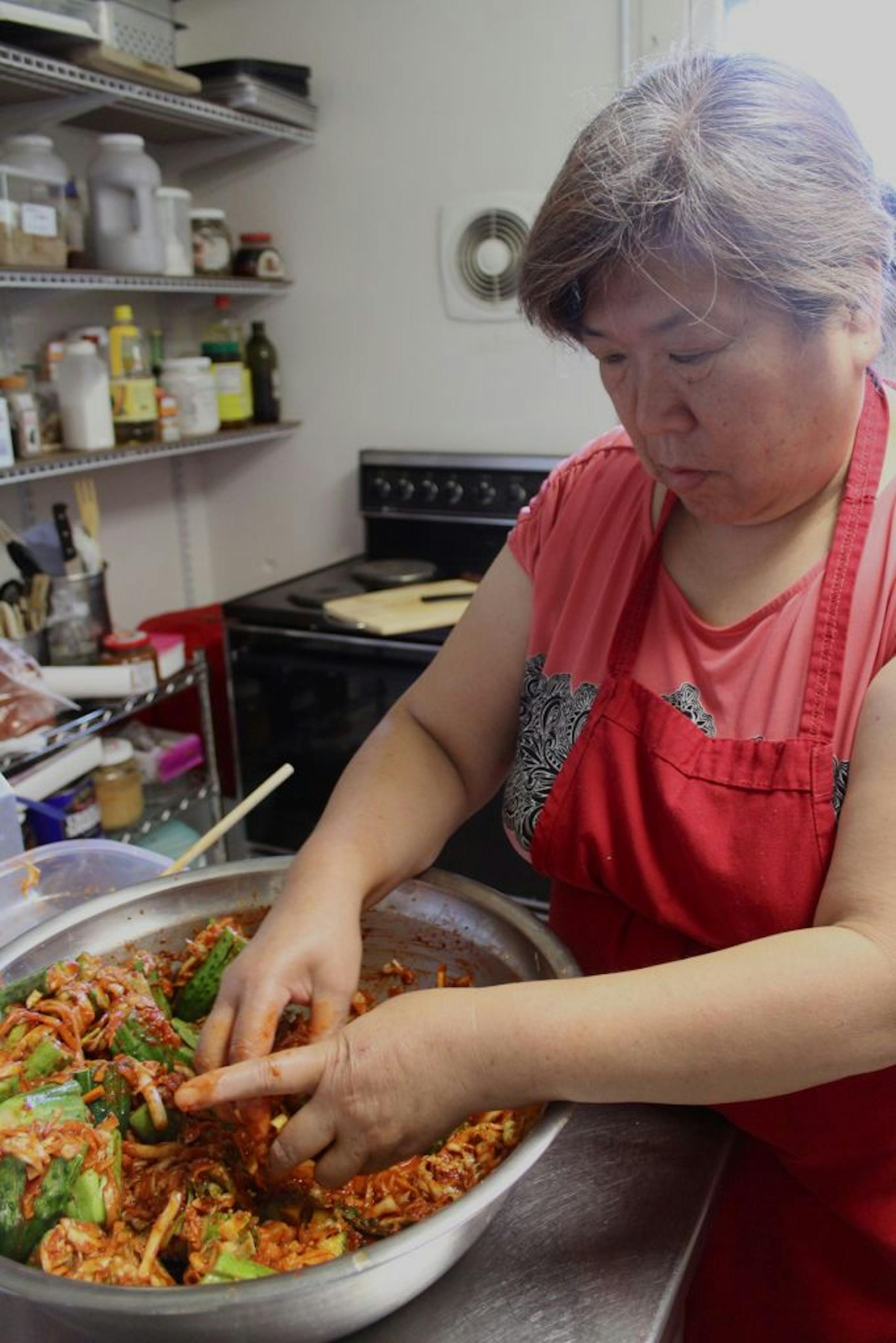 Minam Morris prepares traditional Korean kimchi.