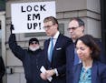 Alex van der Zwaan leaves Federal District Court in Washington, Tuesday, April 3, 2018. Holding the sign up is Bill Christeson from the Washington are