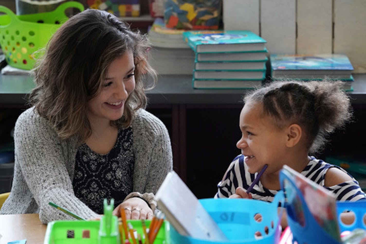 Denfeld High School senior Lindsay Johnson, 17, helped Laura Macarthur Elementary School second grader KaMirra Spencer with her reading as part of the "Pathways2Teaching" program. ] ANTHONY SOUFFLE &#x2022; anthony.souffle@startribune.com High School students from Denfeld High School helped Laura Macarthur Elementary School second graders with their reading Thursday, Dec. 6, 2018 in Duluth. The Duluth school district is joining a Colorado-based program to encourage and help students of color go