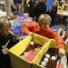 Evan Schroeder, 10, left, and his brother Alec, 7, filled up their boxes with food and dinner supplies as they and about 1000 volunteers at the Mary M