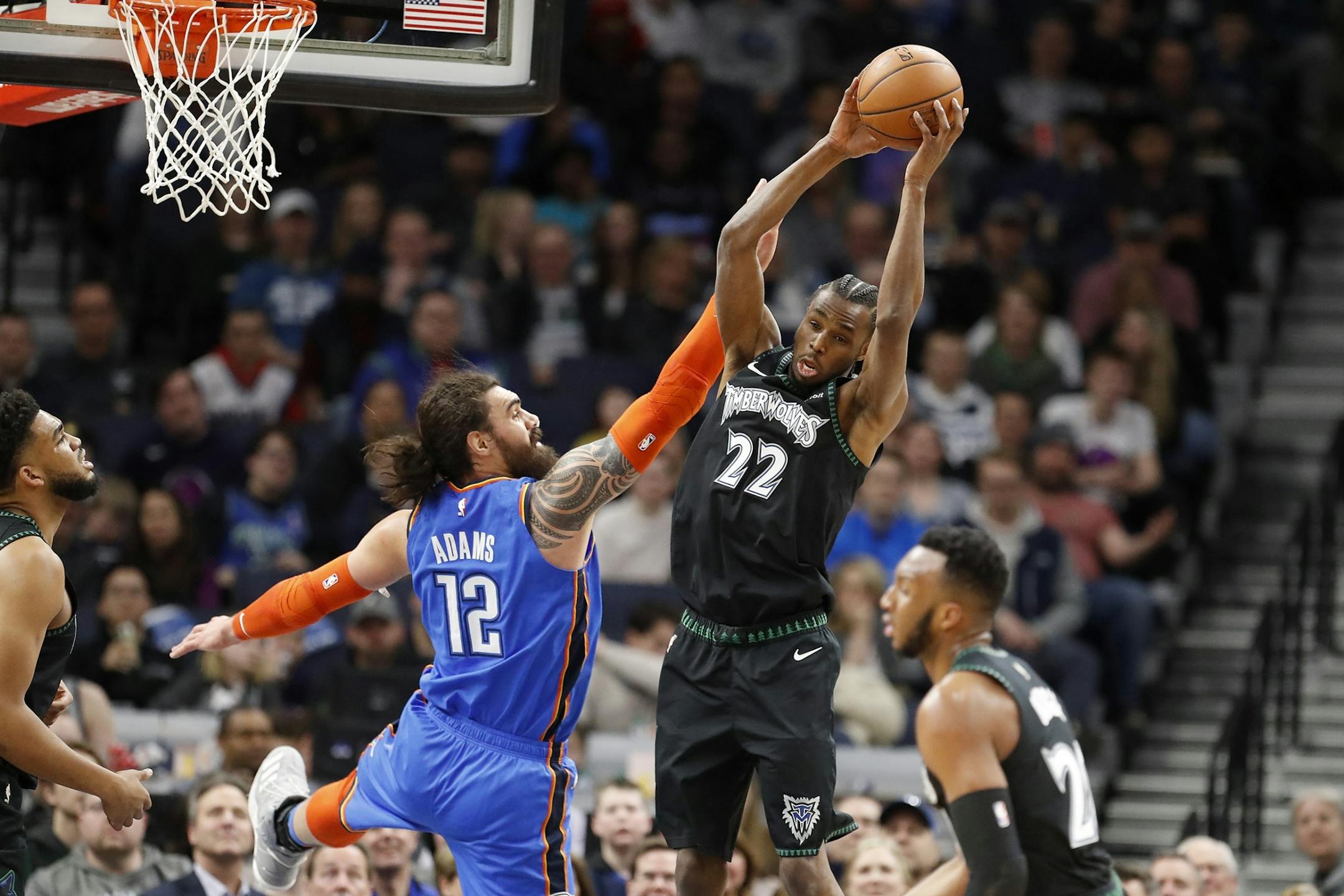 Minnesota Timberwolves forward Andrew Wiggins (22) grabs a rebound from Oklahoma City Thunder center Steven Adams (12) during the first half.
