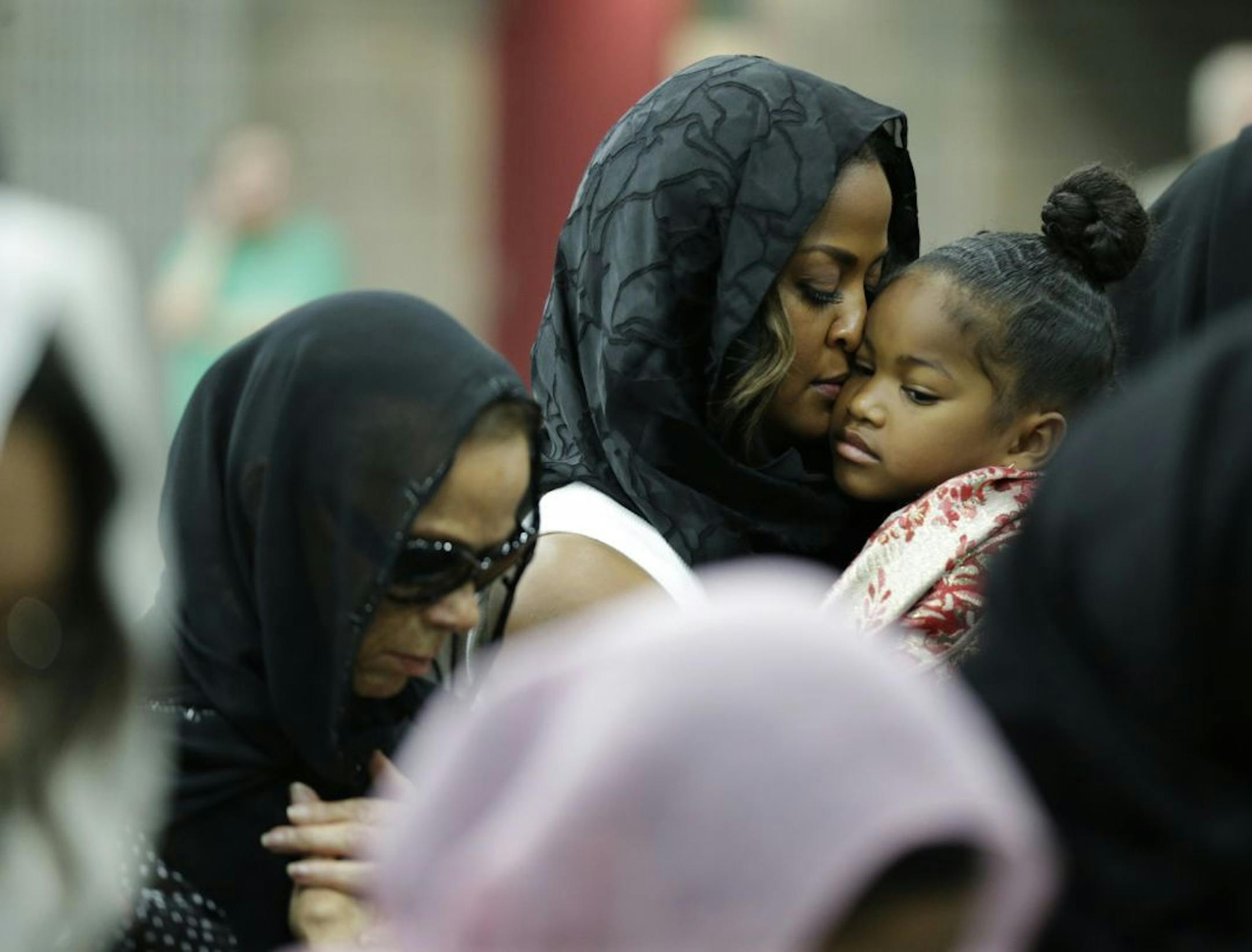 Muhammad Ali's wife Lonnie and her daughter Laila attend Muhammad Ali's Jenazah, a traditional Islamic Muslim service, in Freedom Hall, Thursday, June 9, 2016, in Louisville, Ky. Laila is holding her daughter Sydney Jurldine Conway.