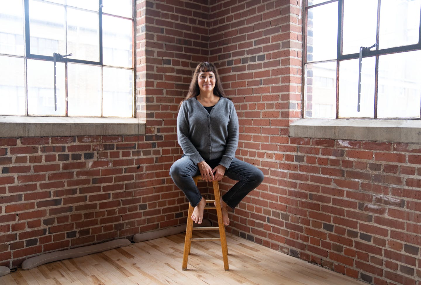 Rosy Simas poses for a portrait Thursday, March 2, 2023 in her studio, three thirty one space, in the Northrup King Building in Minneapolis. ]