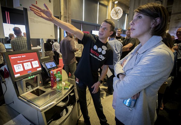 Matthew Howard, a lead project owner, showed visitors the "Self-Checkout," at Target's science fair type event introducing innovation-related projects