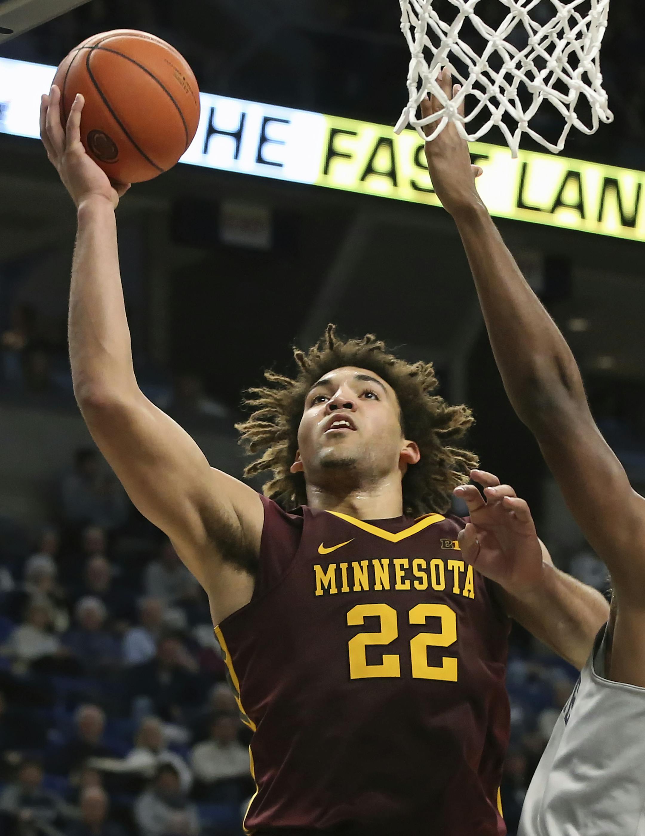 Minnesota's Reggie Lynch (22) goes to the basket as Penn State's Tony Carr (10) defends during the second half of an NCAA college basketball game in State College, Pa., Saturday, Jan. 14, 2017. Penn State won the game 52-50. (AP Photo/Chris Knight)