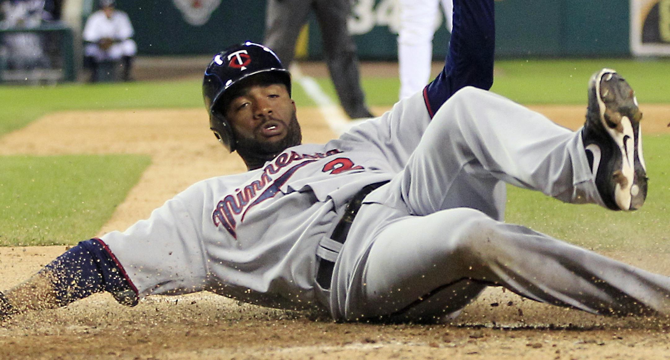 Minnesota Twins' Denard Span scores the go ahead run on a Jamey Carroll single to center during the 10th inning of the second baseball game of a doubleheader against the Detroit Tigers in Detroit, Sunday, Sept. 23, 2012. (AP Photo/Carlos Osorio) ORG XMIT: MICO206