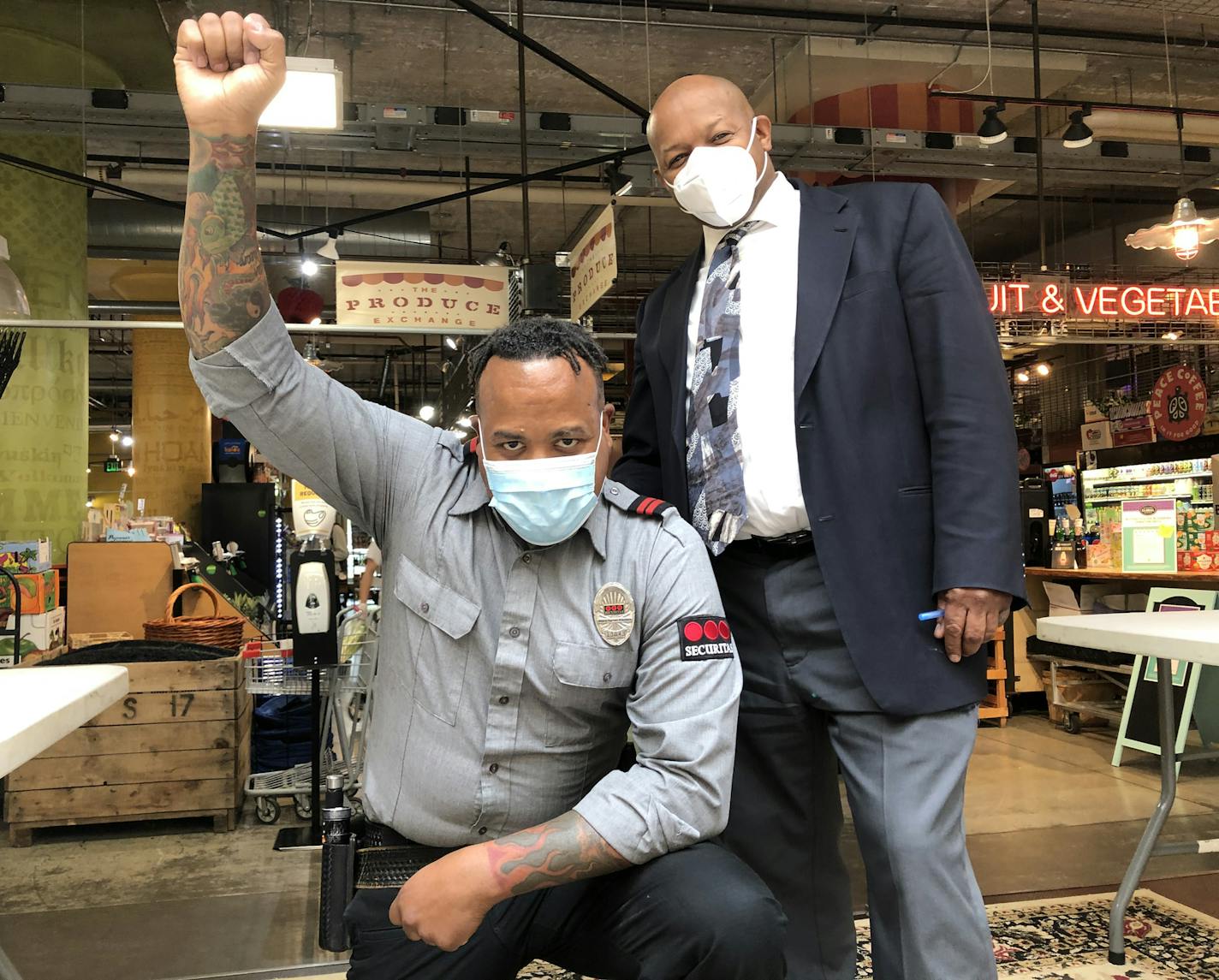 Security officer Ken Reese Jr., left, led the defense of the Midtown Global Market from vandals and looters. With him is market director Earlsworth "Baba" Letang.