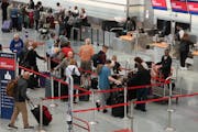 Delta customers waited to check bags before their flights ahead of the busy MEA travel weekend Oct. 17, 2023, at Minneapolis-St. Paul International Ai