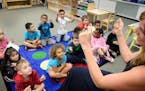Montessori teacher Libby Boyd led her students in a song she created called "How Do We Sit" doing small physical actions like snapping their fingers a