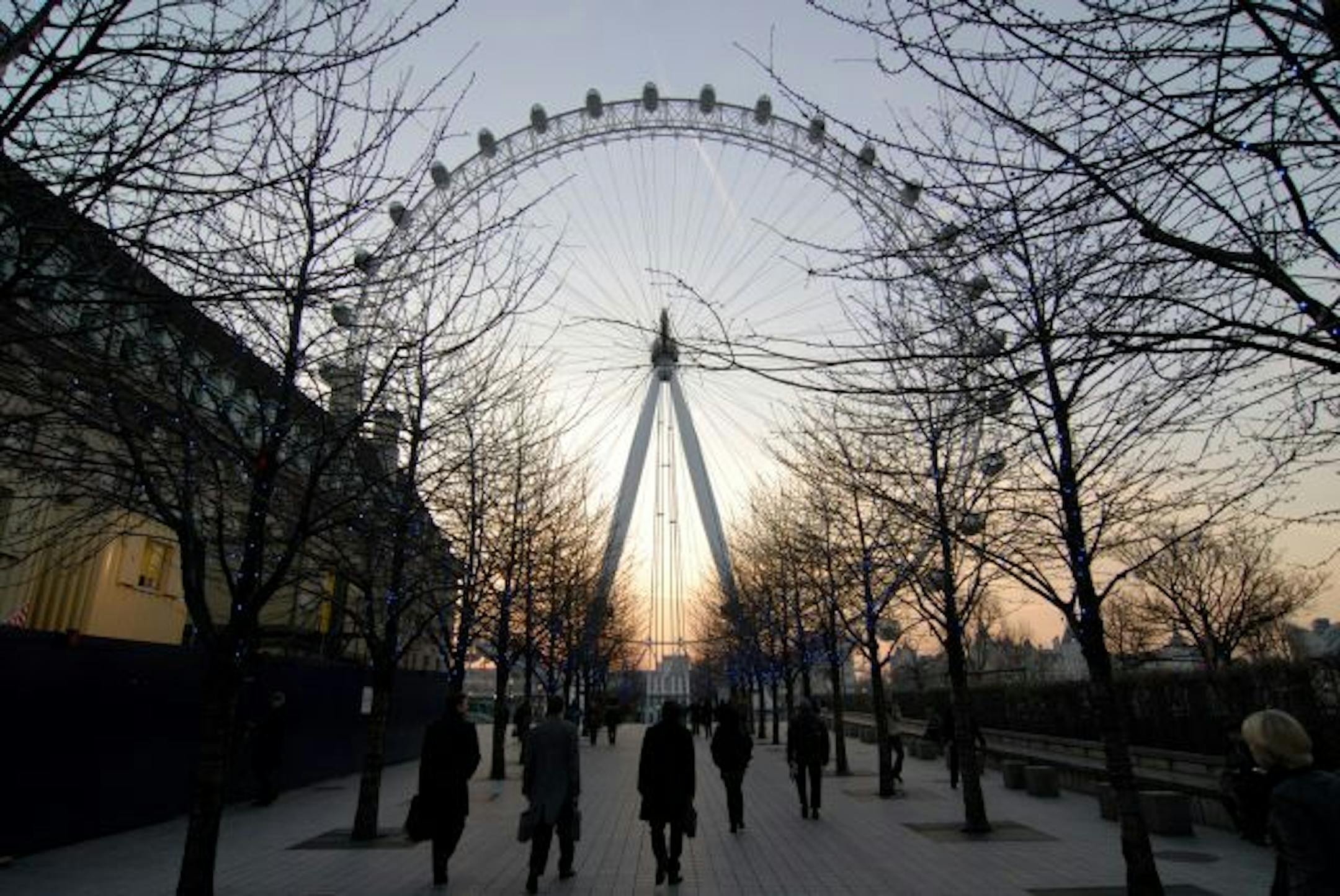 The London Eye towers over the south bank of River Thames in London.